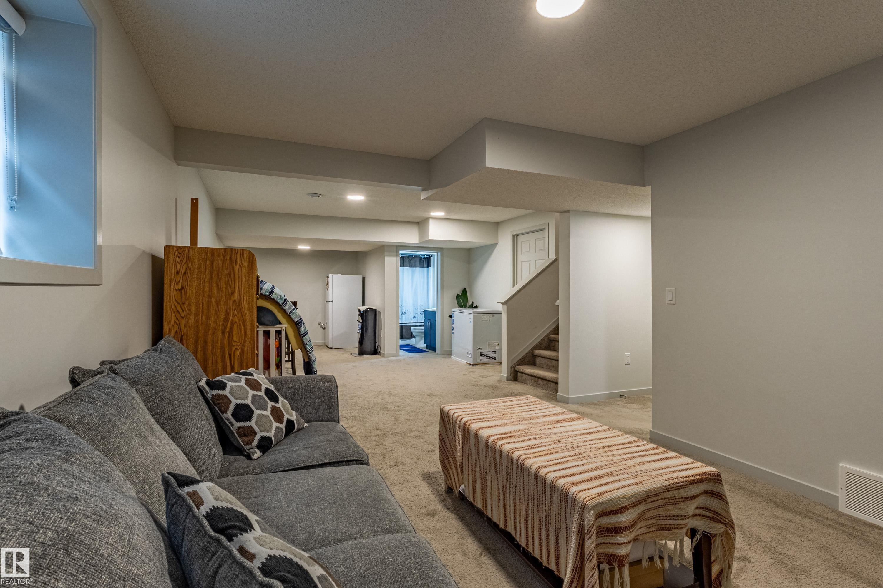 Lower level featuring neutral carpeting, recessed lighting, painted walls, and a visible window - 41 Sequoia Bend, Fort Saskatchewan, AB