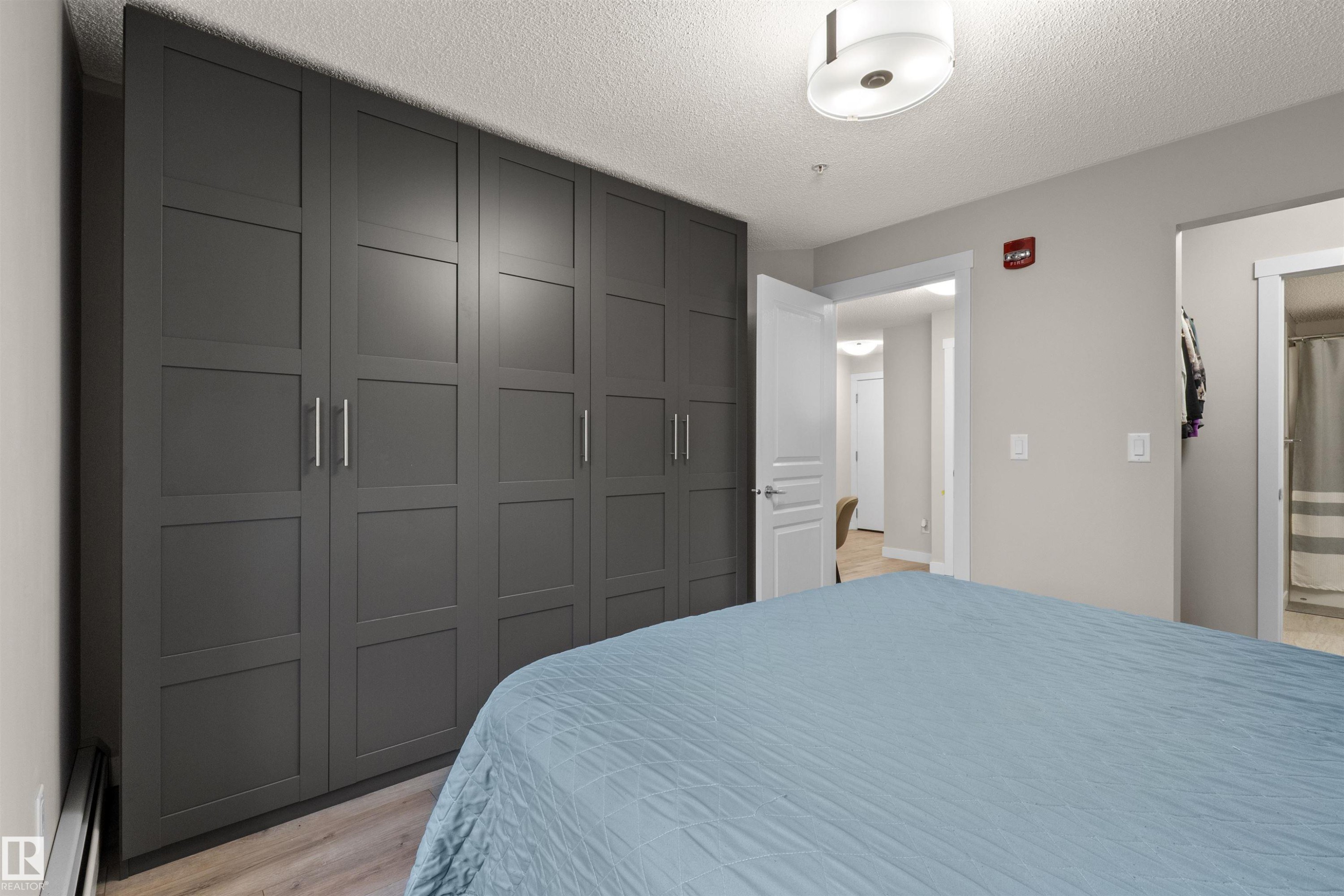 Expansive built-in wardrobe featuring contemporary panel doors and brushed nickel hardware - 210 2229 44 Avenue, Edmonton, AB