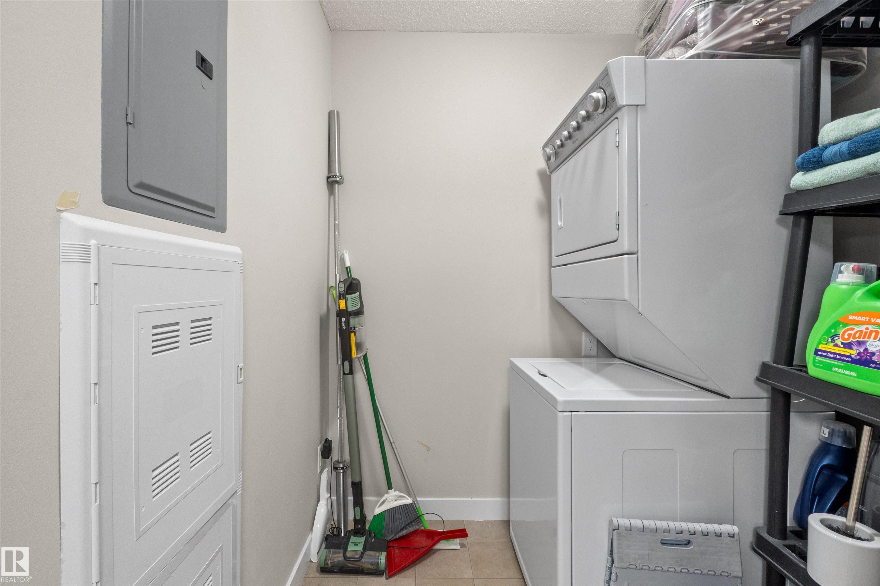 Dedicated laundry area featuring a stacked washer and dryer - 210 2229 44 Avenue, Edmonton, AB