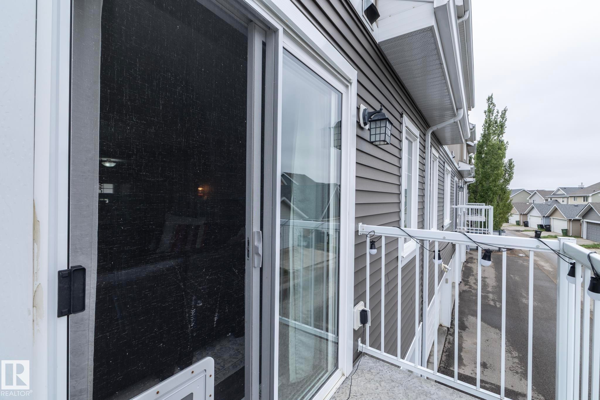 Exterior balcony featuring white metal railings - 46 4050 Savaryn Drive, Edmonton, AB
