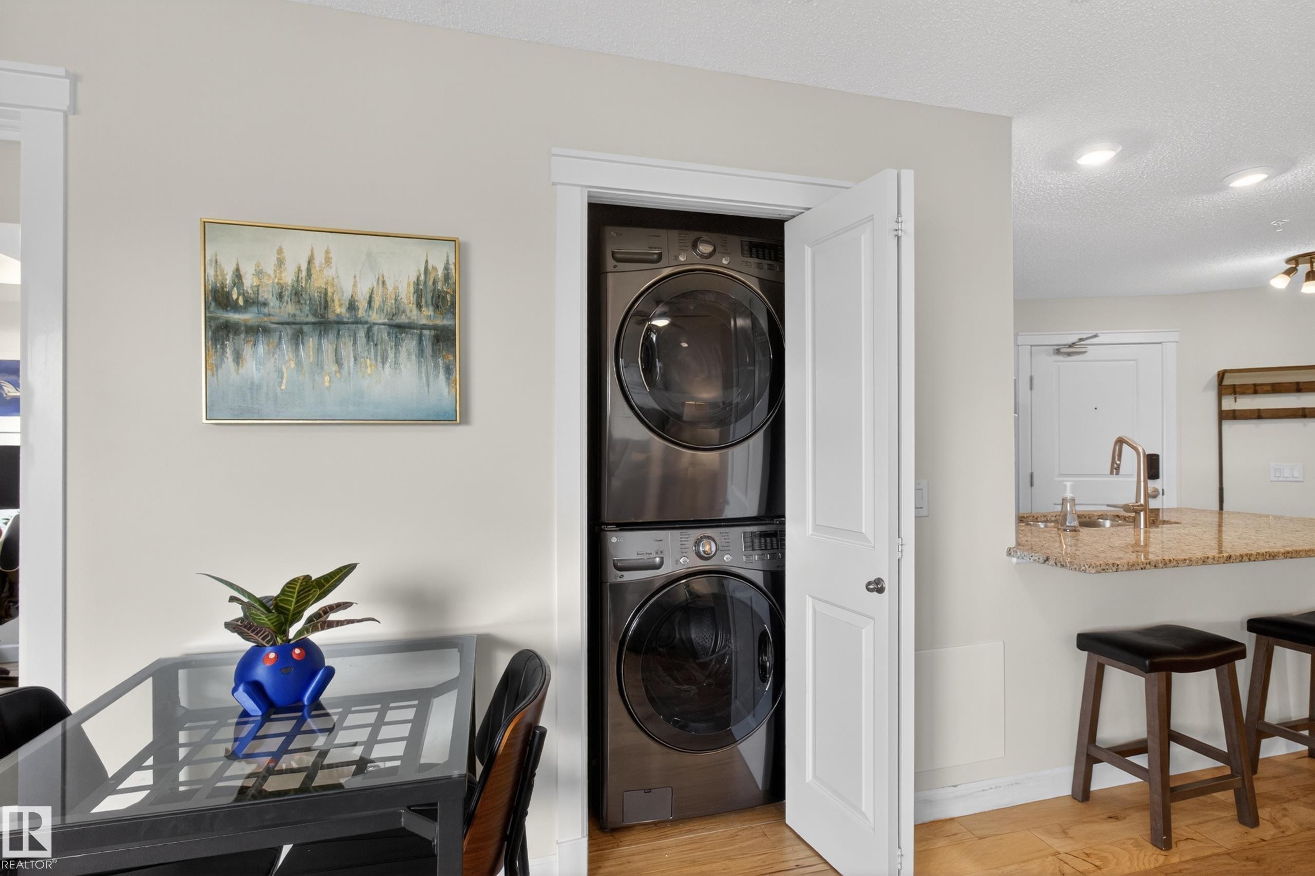 Dedicated laundry closet with stacked washer and dryer units - 211 3719 Whitelaw Lane, Edmonton, AB