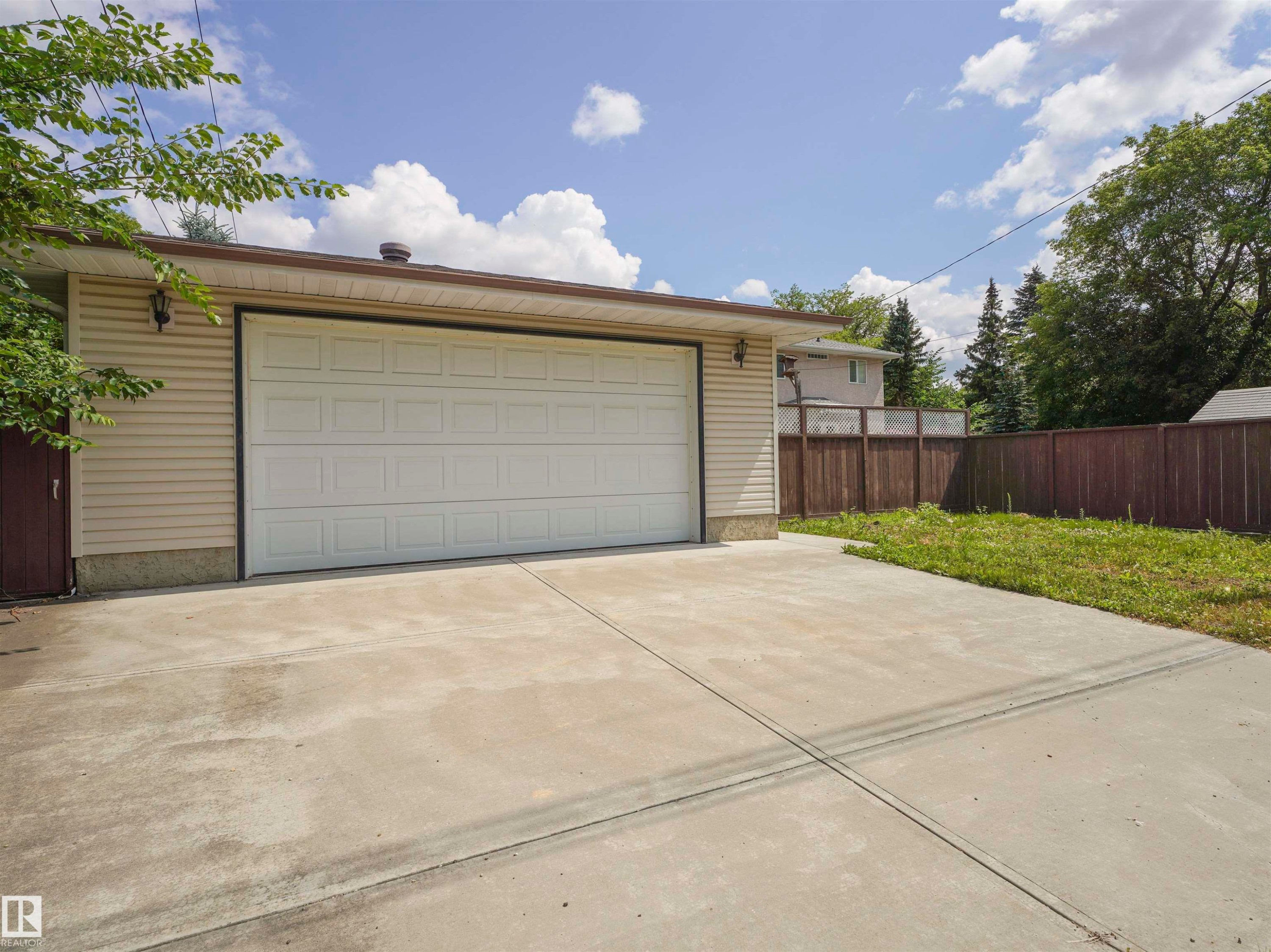 Notice the huge concrete driveway and large parking area adjacent to the detached double garage. - 9608 150 Street Nw, Edmonton, AB