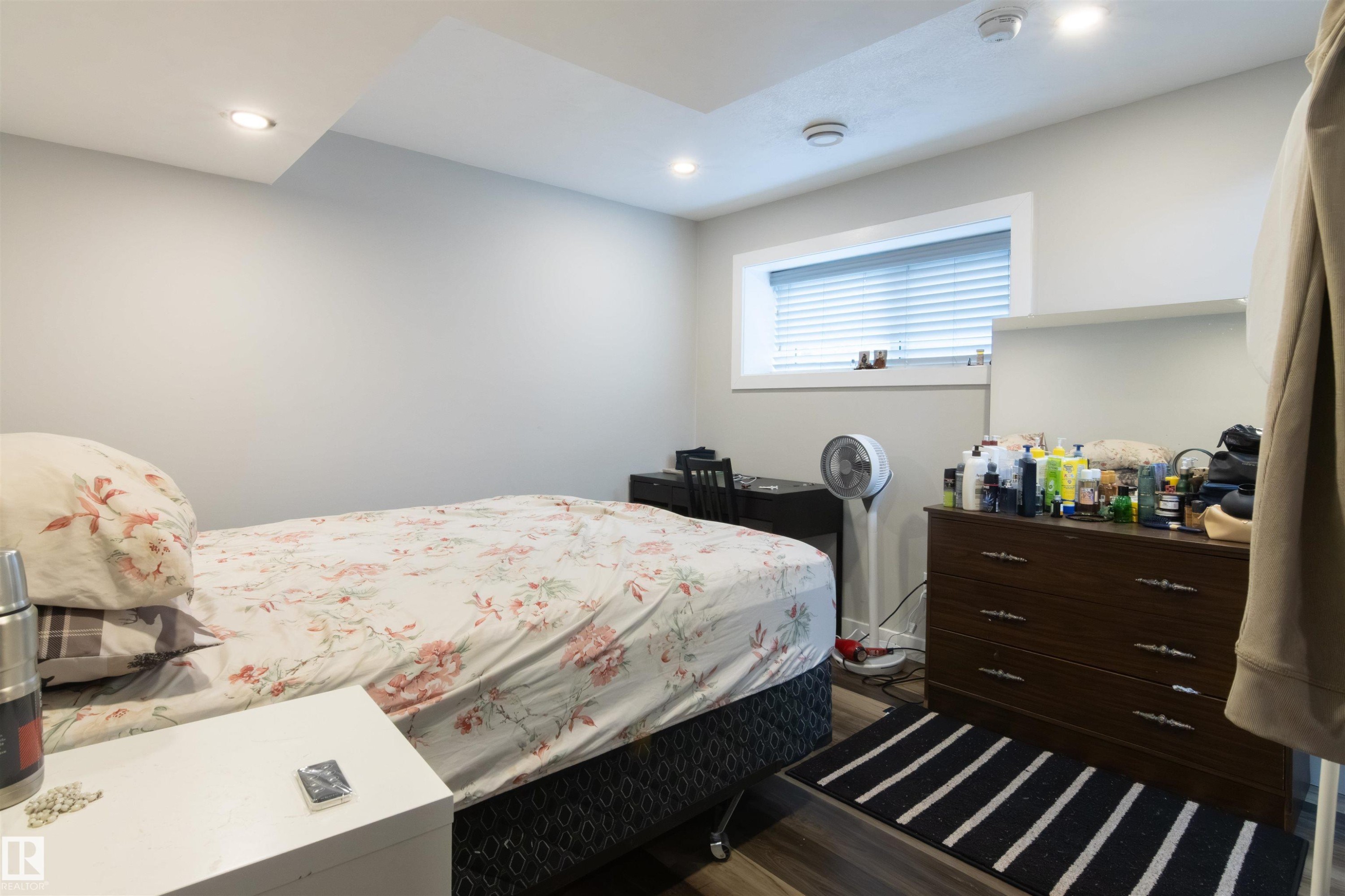 Room featuring wood-finish flooring, recessed lighting, and a window with blinds - 4004 88 Street Nw, Edmonton, AB - Indoor Photo Showing Bedroom