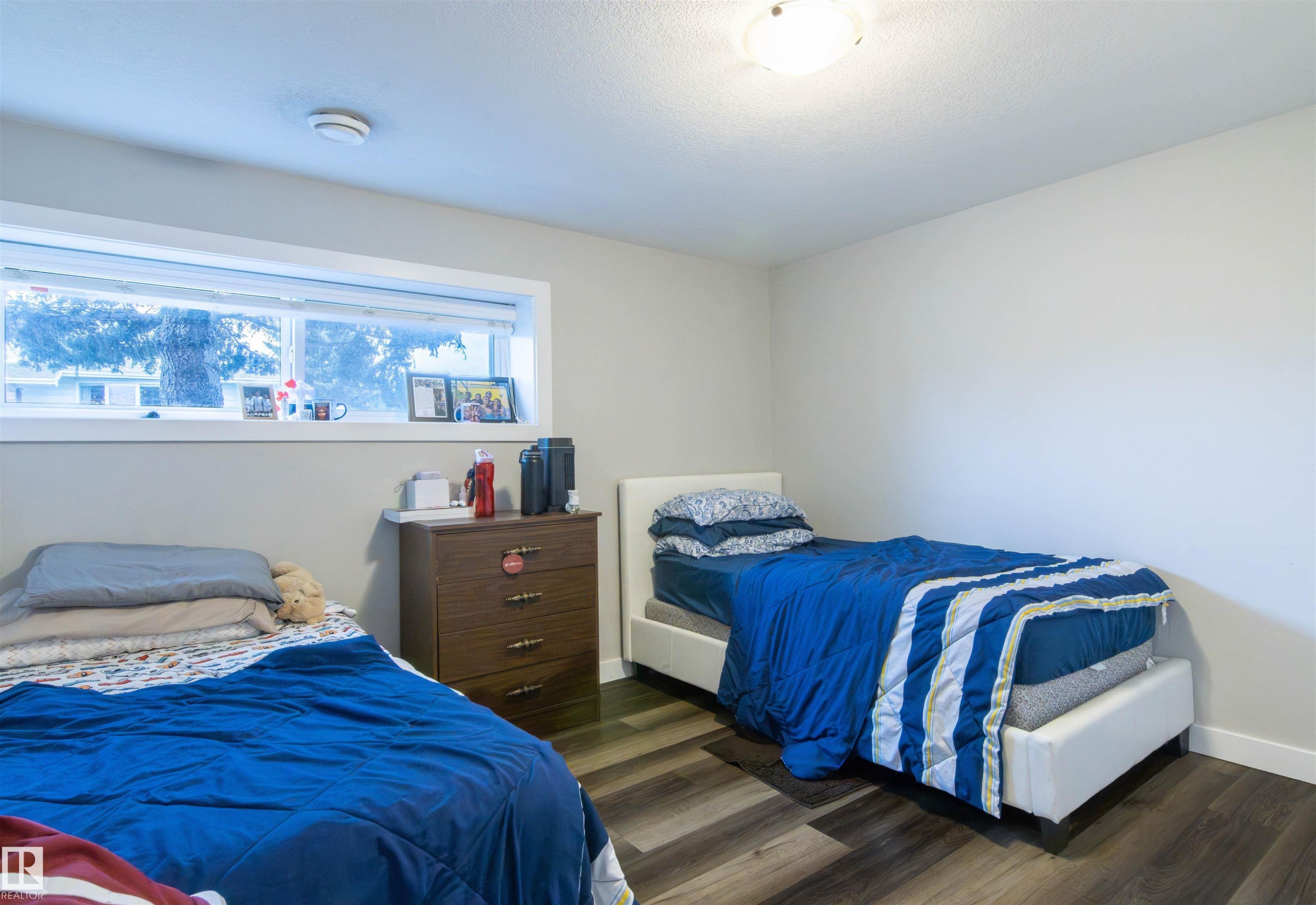 Room featuring wood-finish flooring and light gray walls - 4004 88 Street Nw, Edmonton, AB - Indoor Photo Showing Bedroom