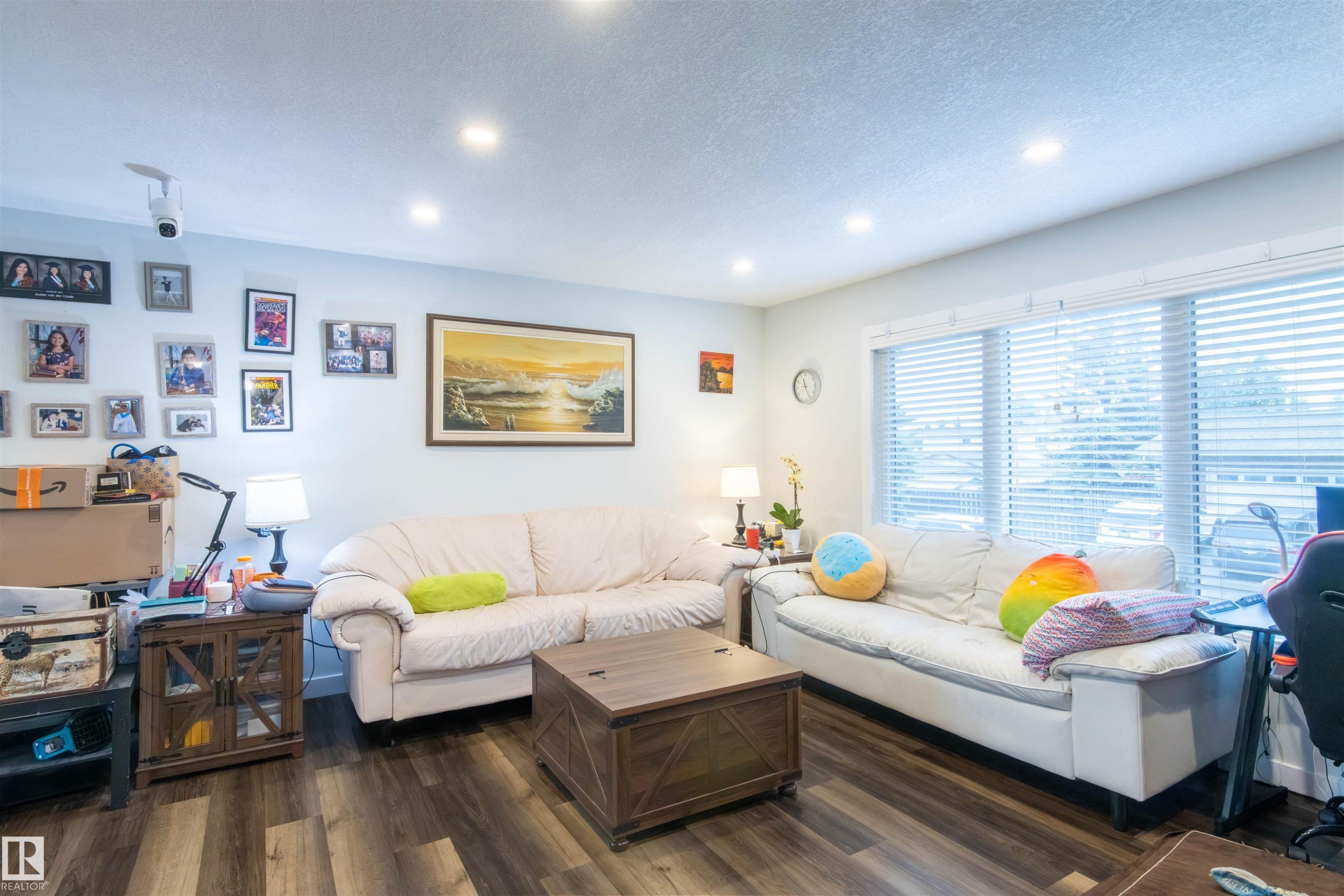 Spacious interior with wood-finish flooring, recessed lighting, and large windows with blinds - 4004 88 Street Nw, Edmonton, AB - Indoor Photo Showing Living Room
