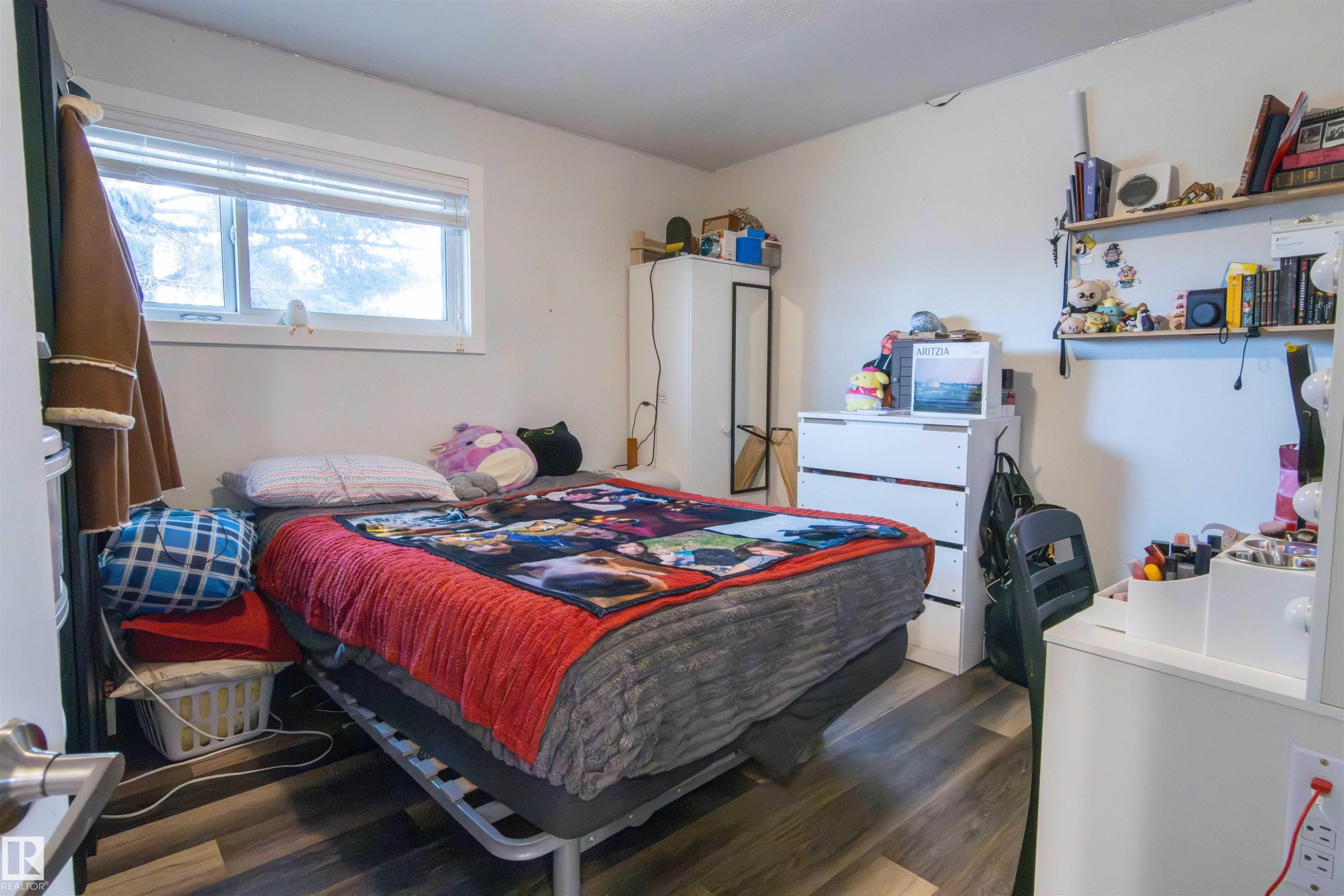 Bedroom featuring wood-finish flooring, a white-framed window, and white walls - 4004 88 Street Nw, Edmonton, AB - Indoor Photo Showing Bedroom