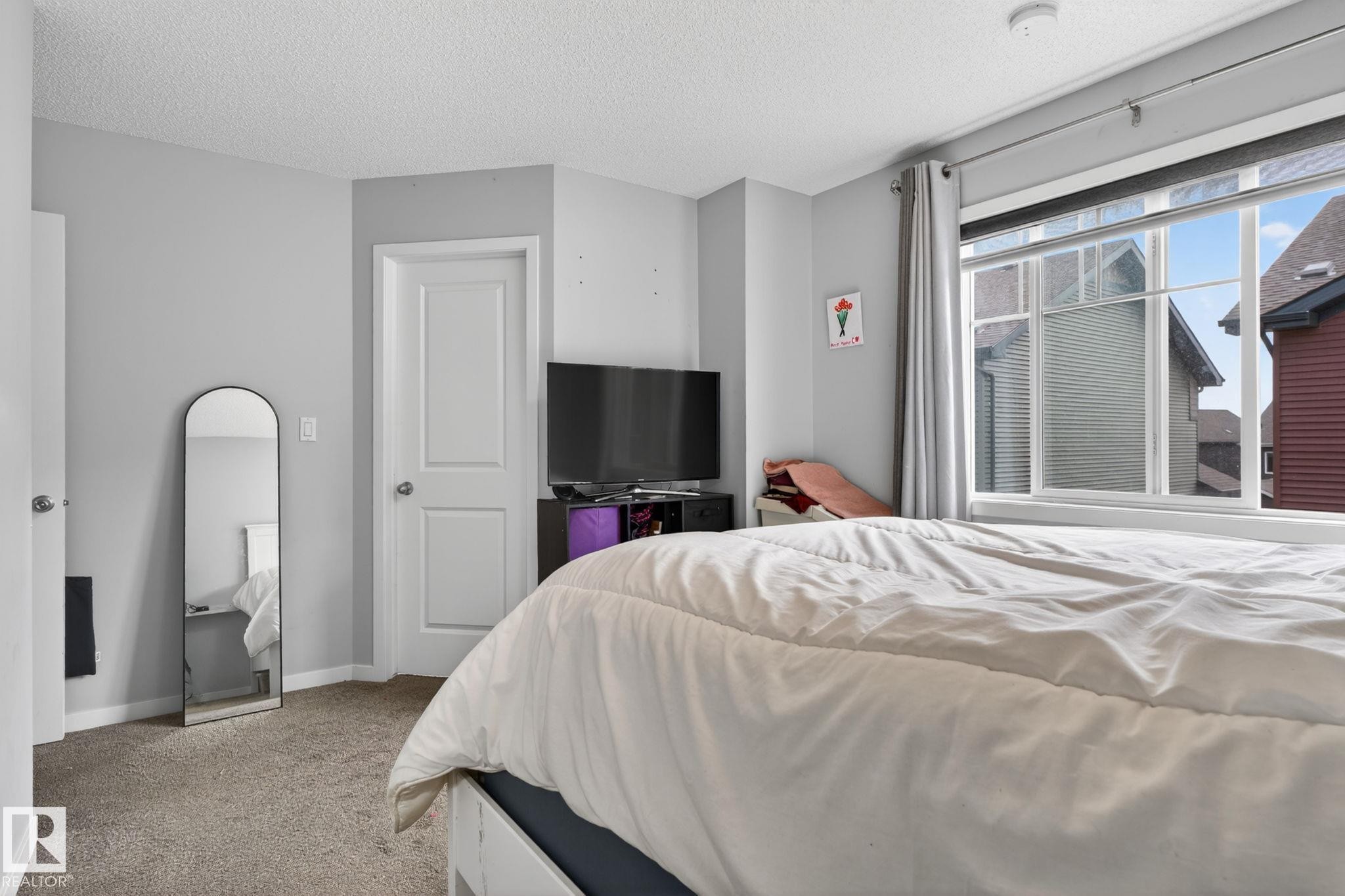 Windowed room featuring light gray painted walls and textured carpet flooring - 62 3305 Orchards Link, Edmonton, AB