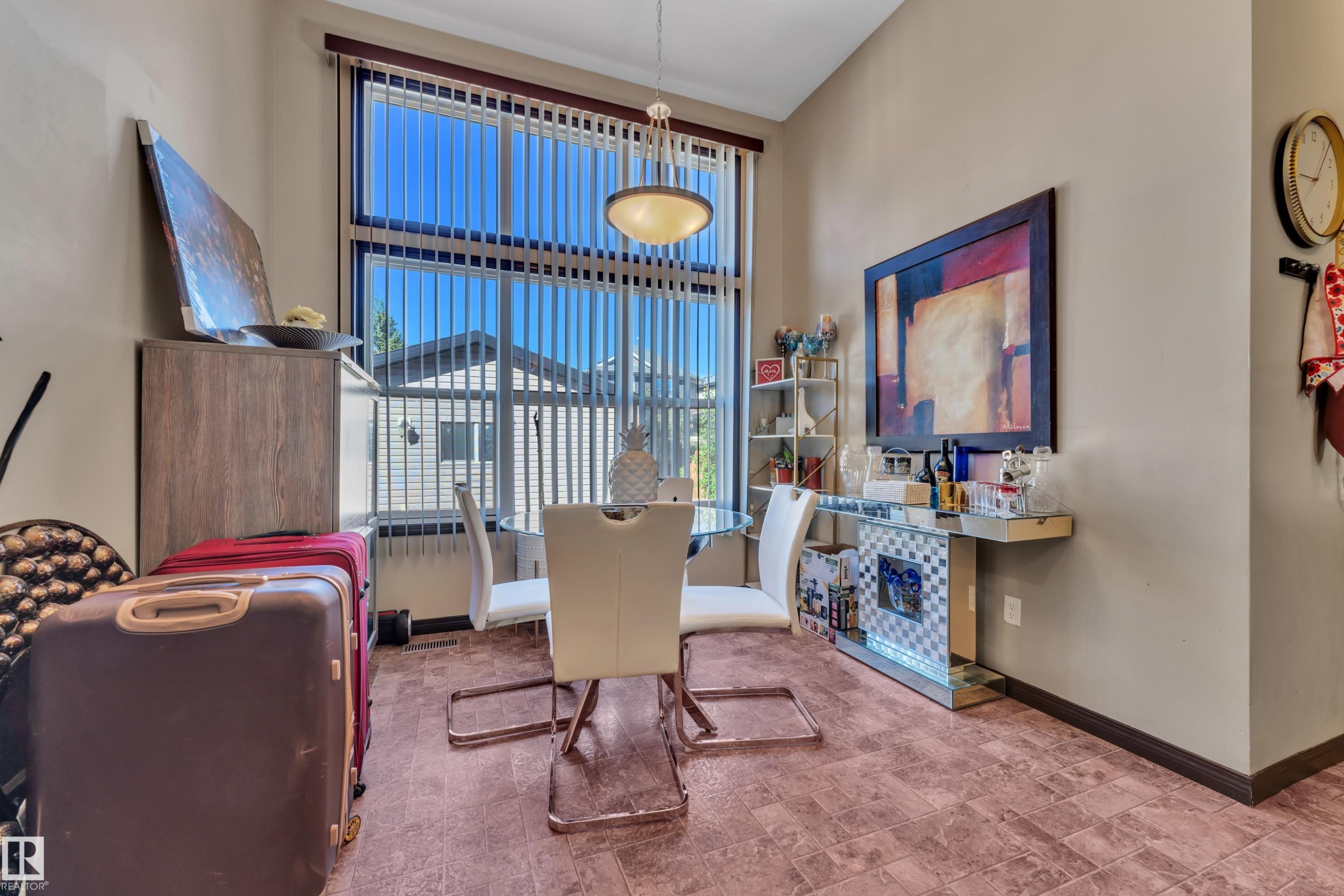 Dining area featuring a large window with vertical blinds, textured flooring, and neutral wall tones - 621 Mcdonough Link Link, Edmonton, AB