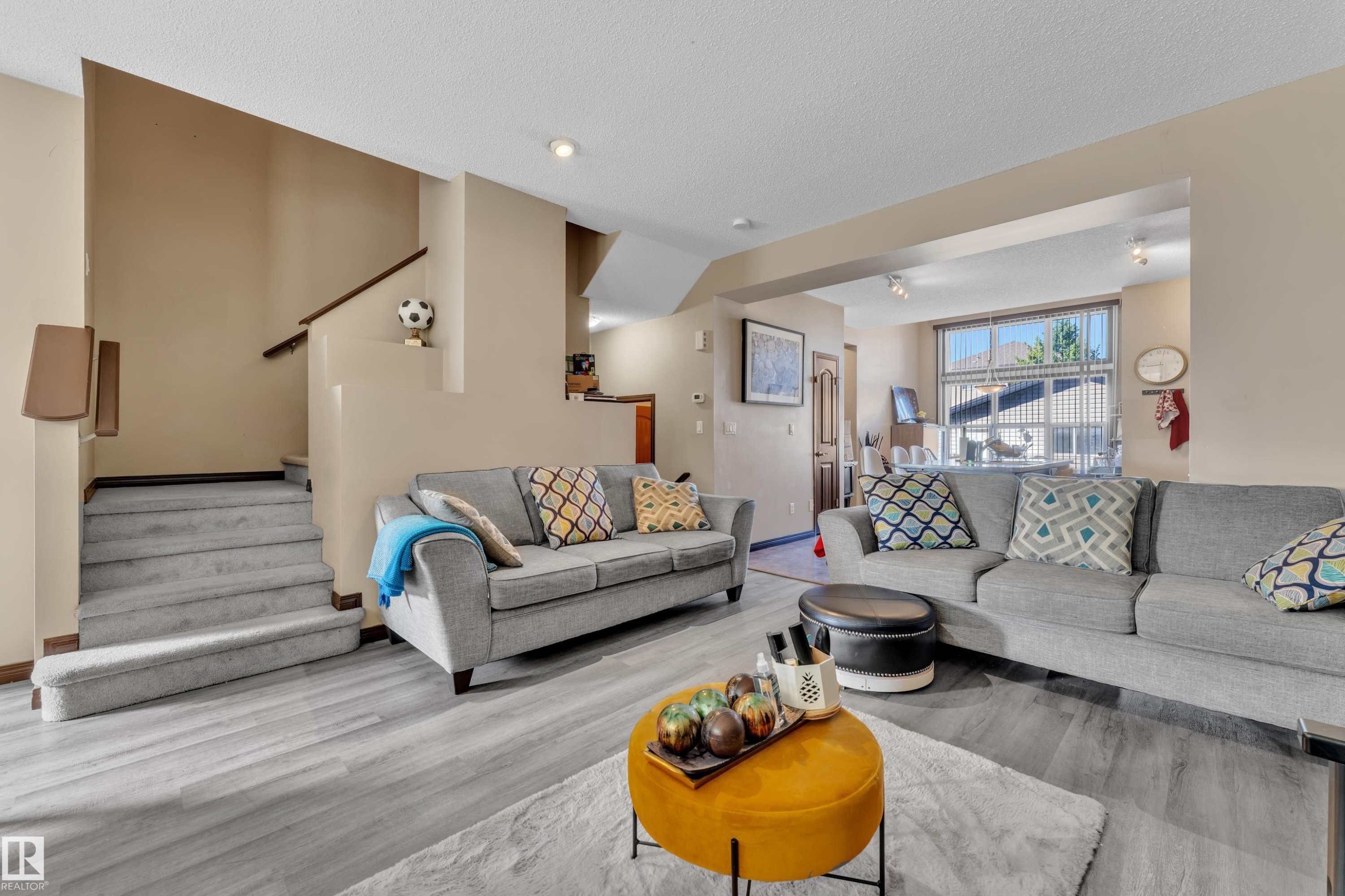 Living area featuring light wood-finish flooring and neutral wall tones - 621 Mcdonough Link Link, Edmonton, AB