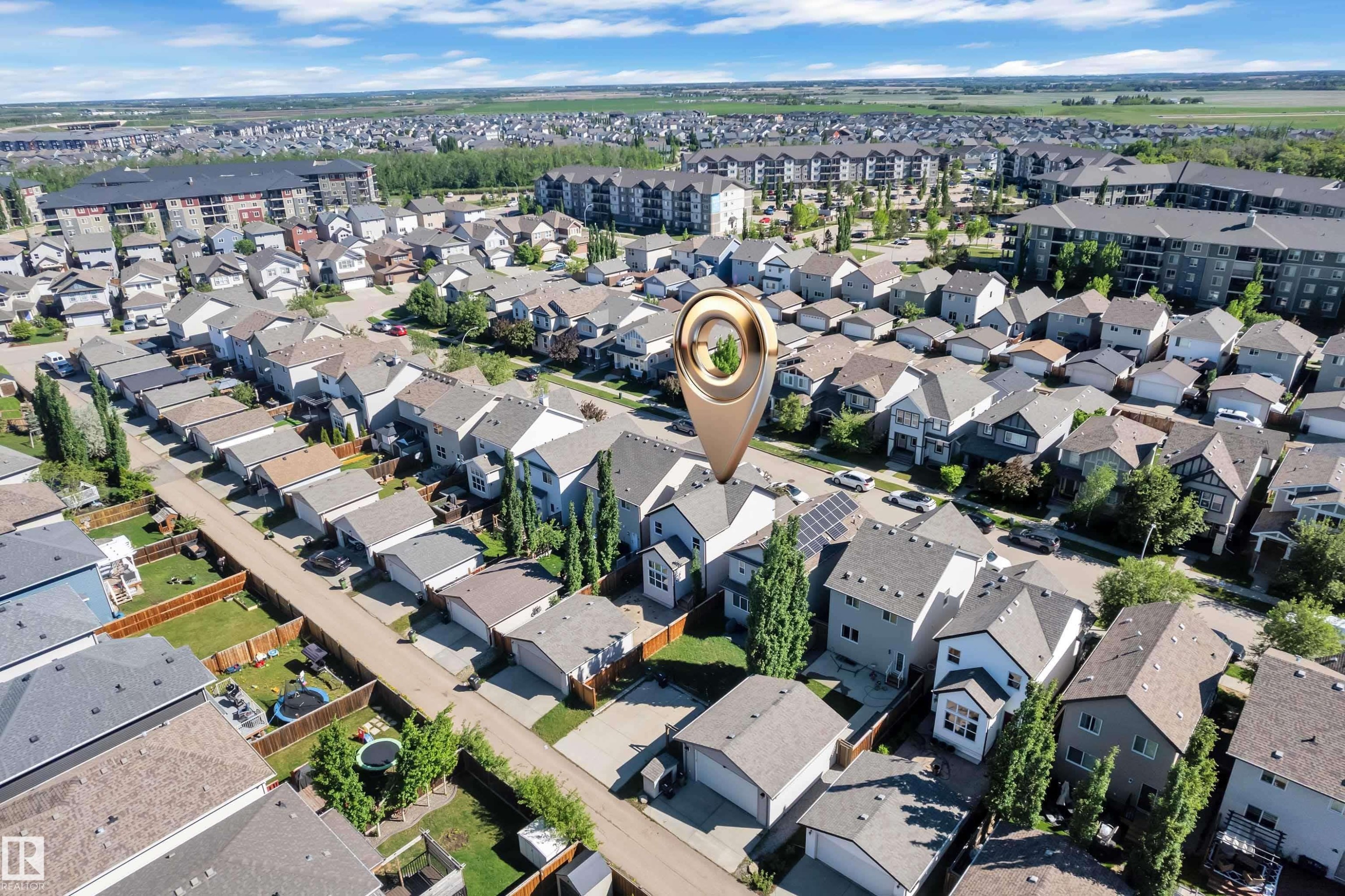 Aerial perspective showcasing a residential neighborhood with detached homes and multi-story apartment buildings - 621 Mcdonough Link Link, Edmonton, AB