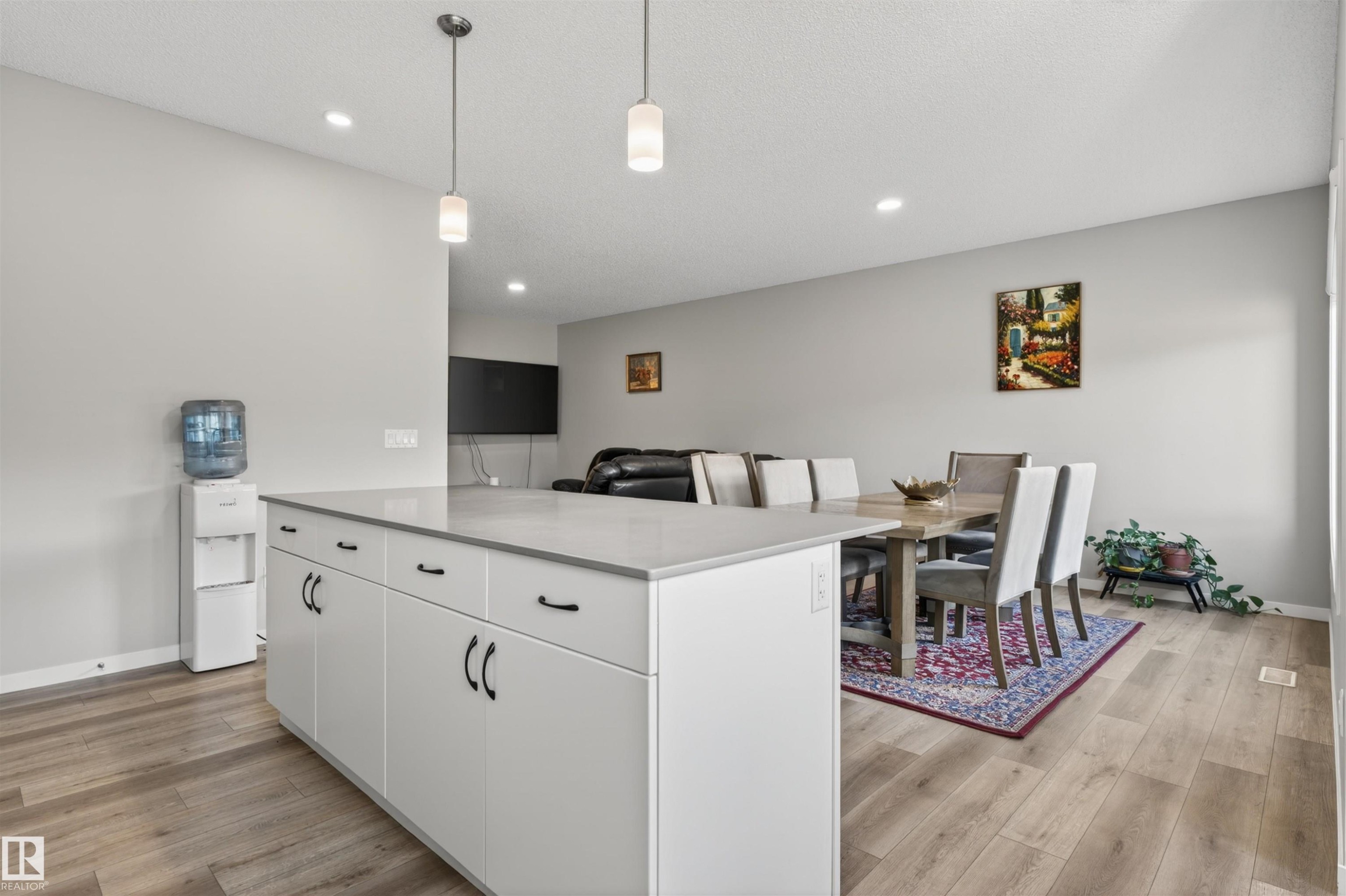 Kitchen island featuring white cabinetry, dark hardware, and a light-toned countertop - 22638 99A Avenue, Edmonton, AB