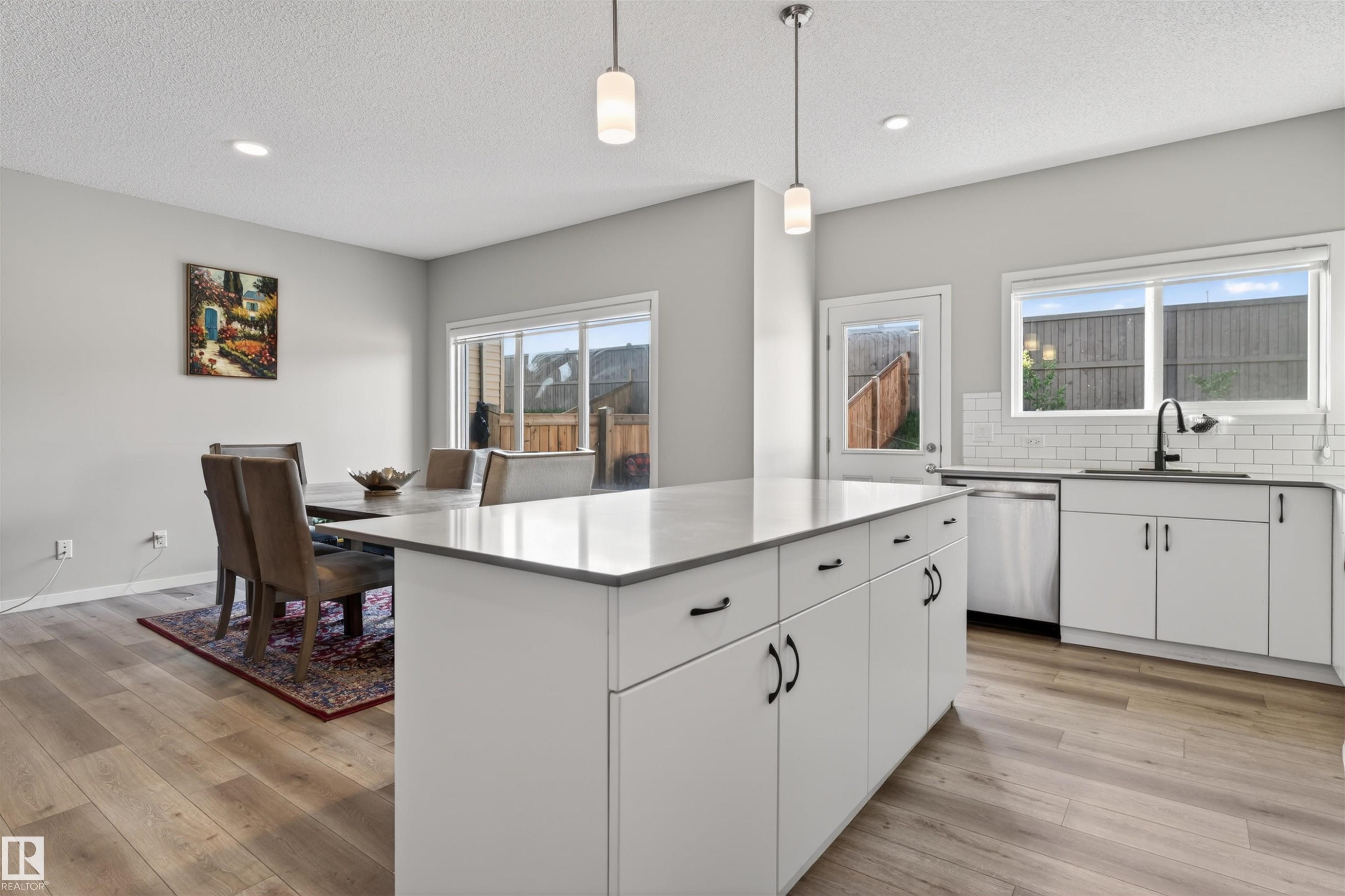 Open-concept kitchen and dining area with wood-finish flooring - 22638 99A Avenue, Edmonton, AB