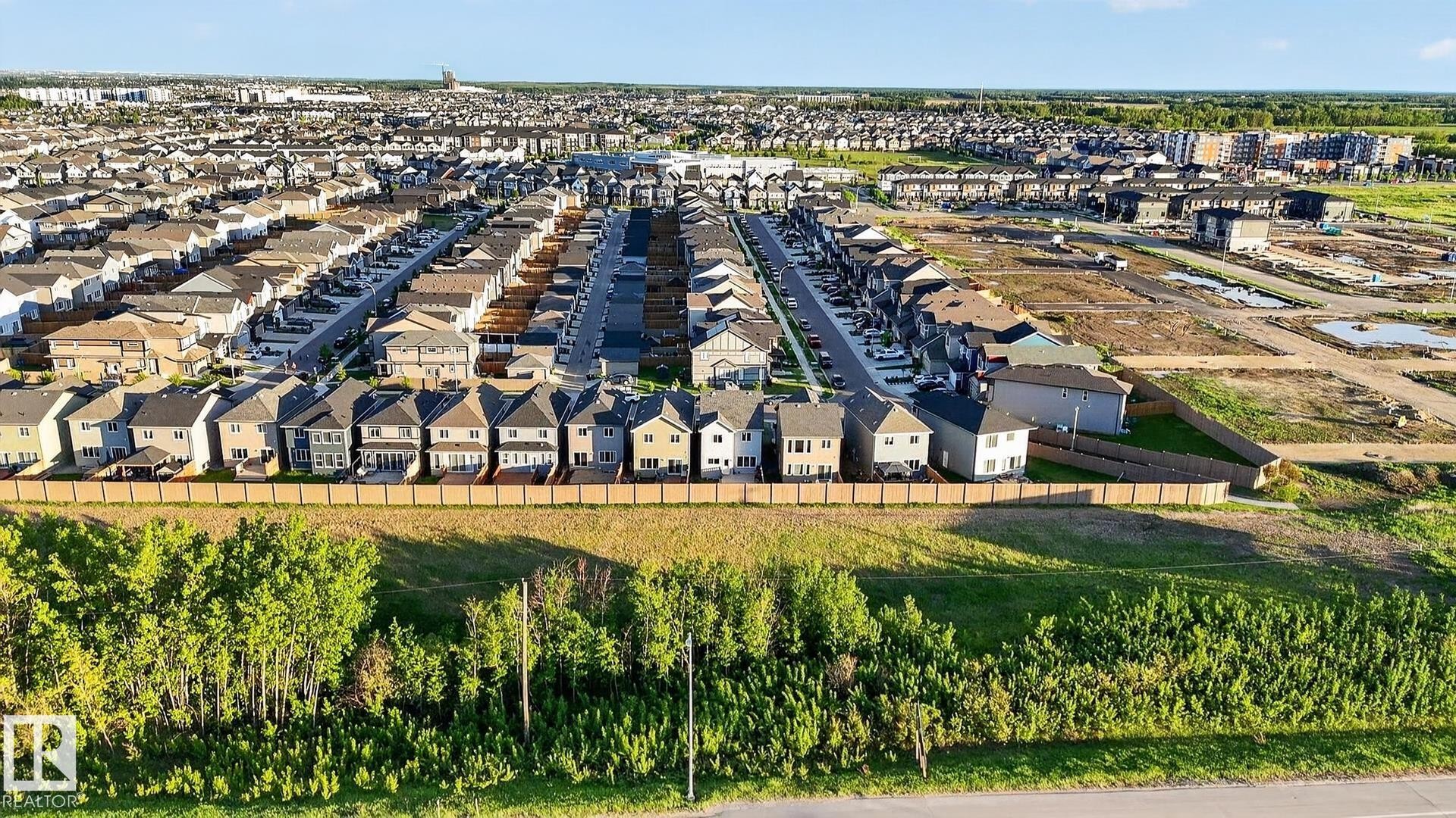 Expansive residential development featuring numerous newly constructed homes, paved streets, and a mix of completed and developing lots - 22638 99A Avenue, Edmonton, AB