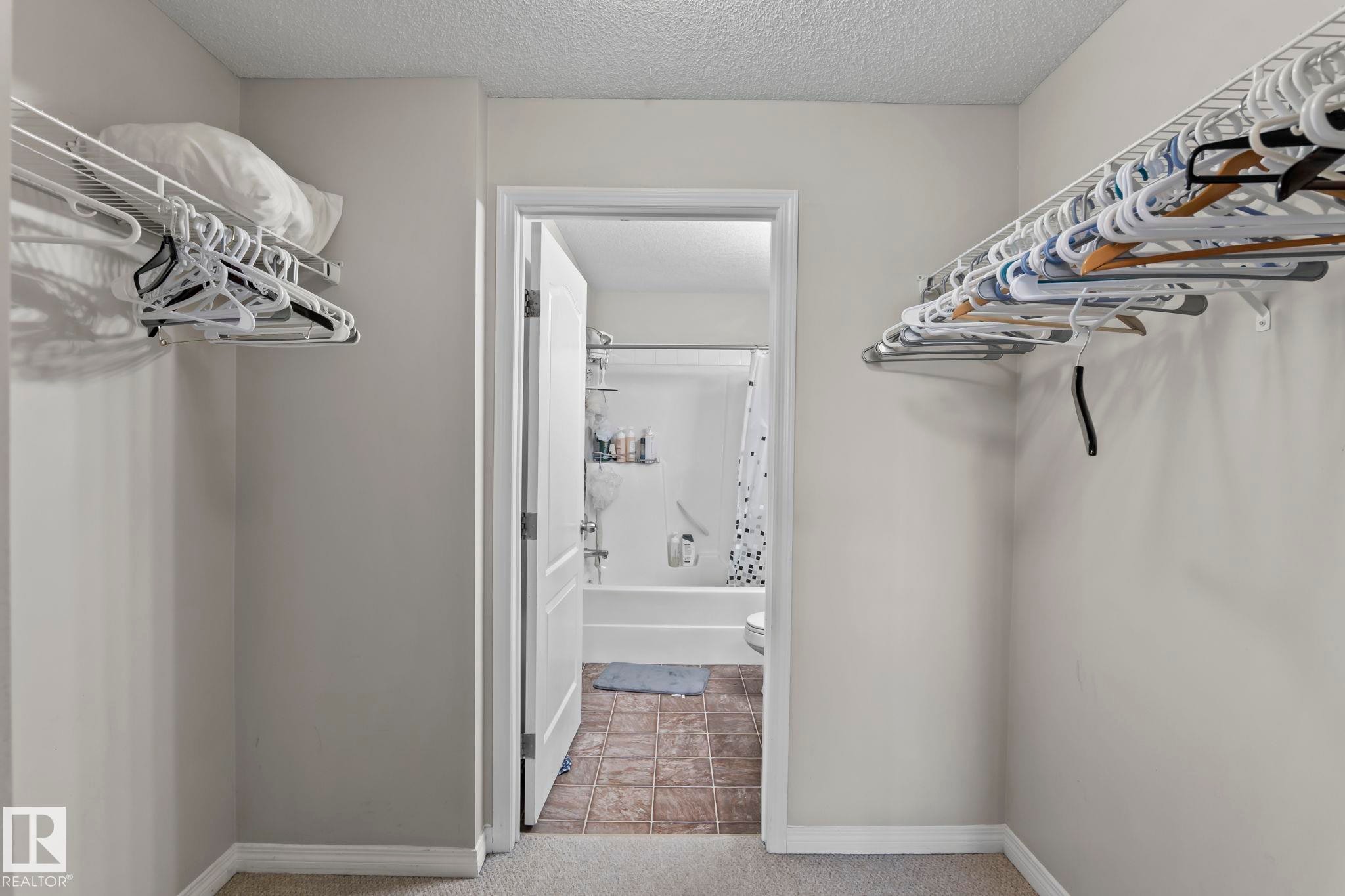 Walk-in closet featuring wire shelving and carpet flooring - 2106 9357 Simpson Dr Nw, Edmonton, AB - Indoor With Storage