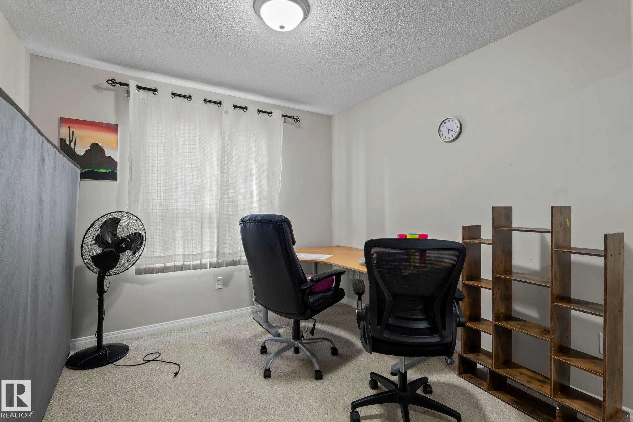 Room featuring neutral-toned walls, textured ceiling, and light-colored carpet flooring - 2106 9357 Simpson Dr Nw, Edmonton, AB - Indoor Photo Showing Office