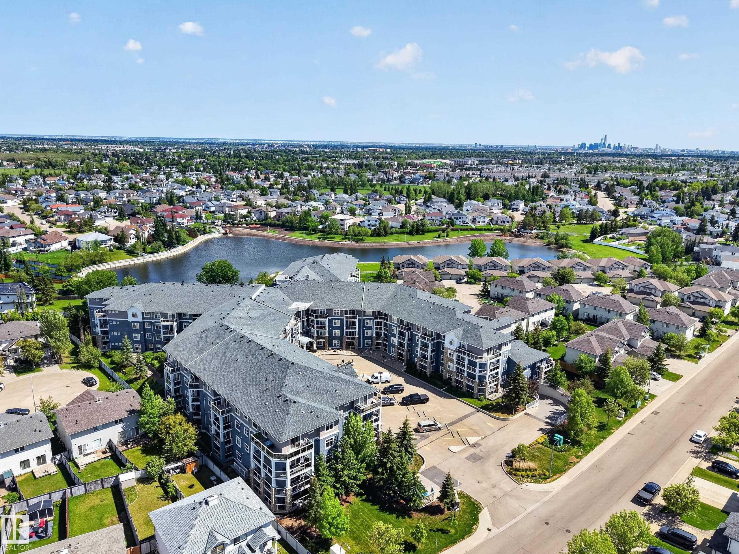 Modern multi-story building featuring multiple balconies and a dark shingled roof - 138 16035 132 Street, Edmonton, AB