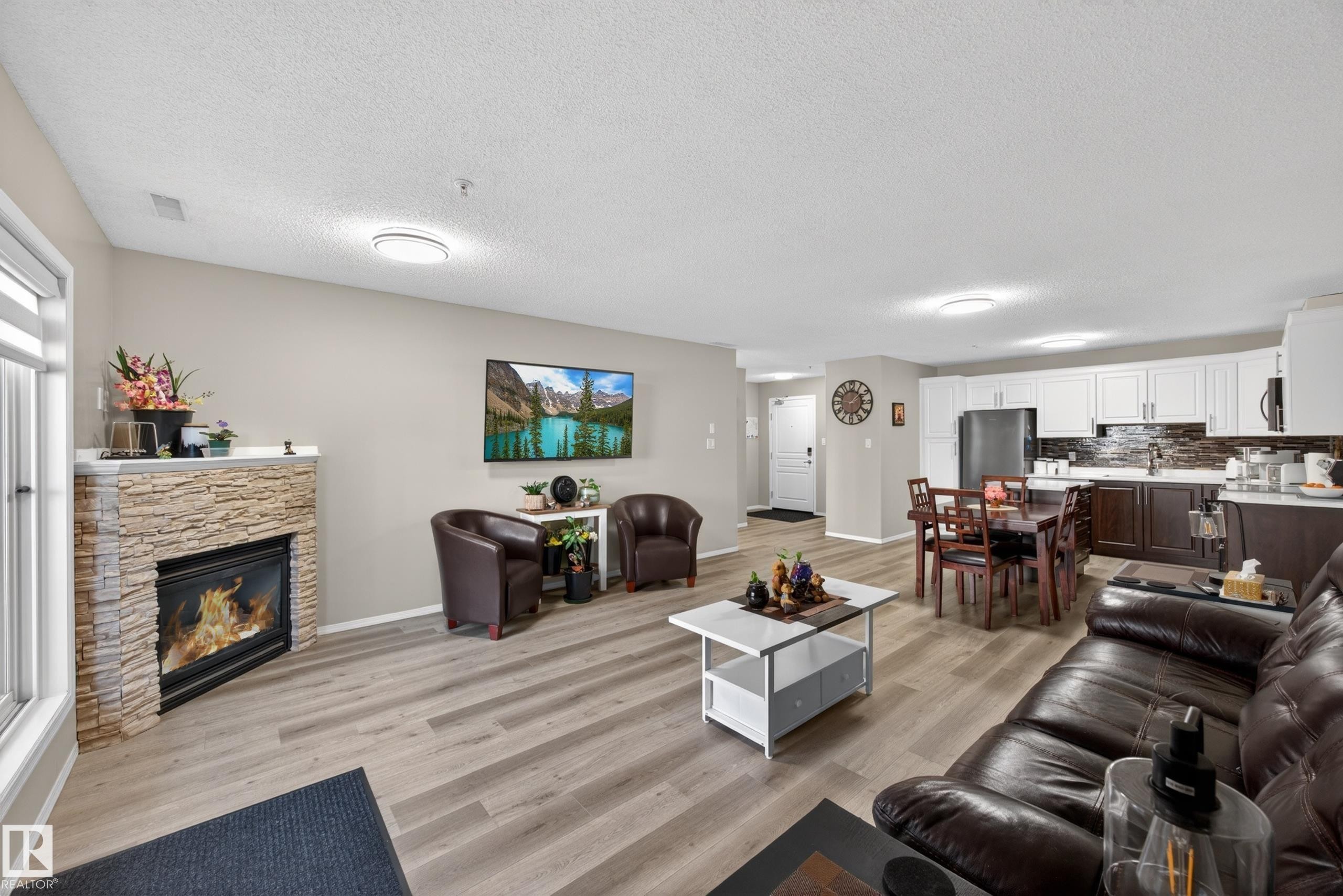 Open concept living area featuring wood-finish flooring - 138 16035 132 Street, Edmonton, AB