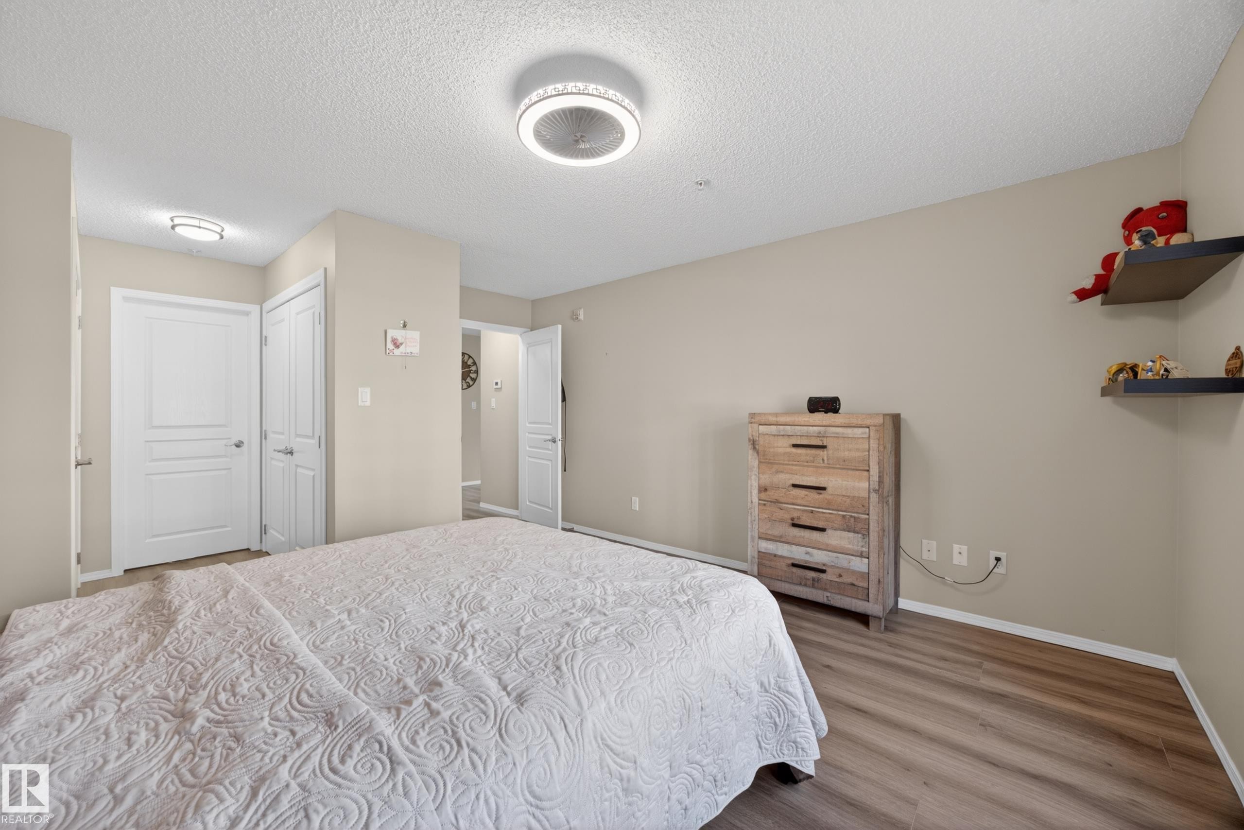 Neutral-toned room featuring light wood-finish flooring - 138 16035 132 Street, Edmonton, AB