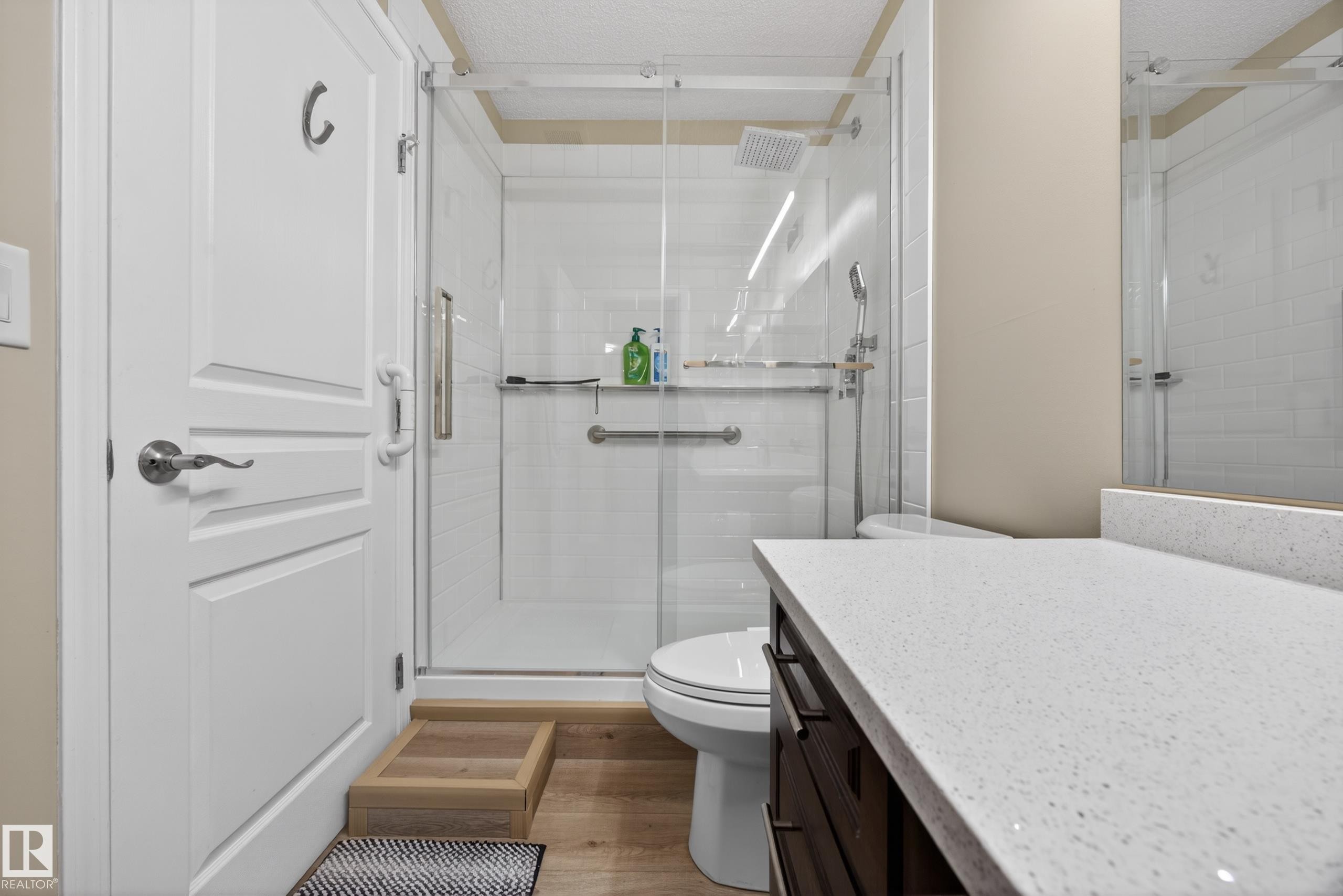 Glass-enclosed shower with subway tile surround and rain showerhead - 138 16035 132 Street, Edmonton, AB