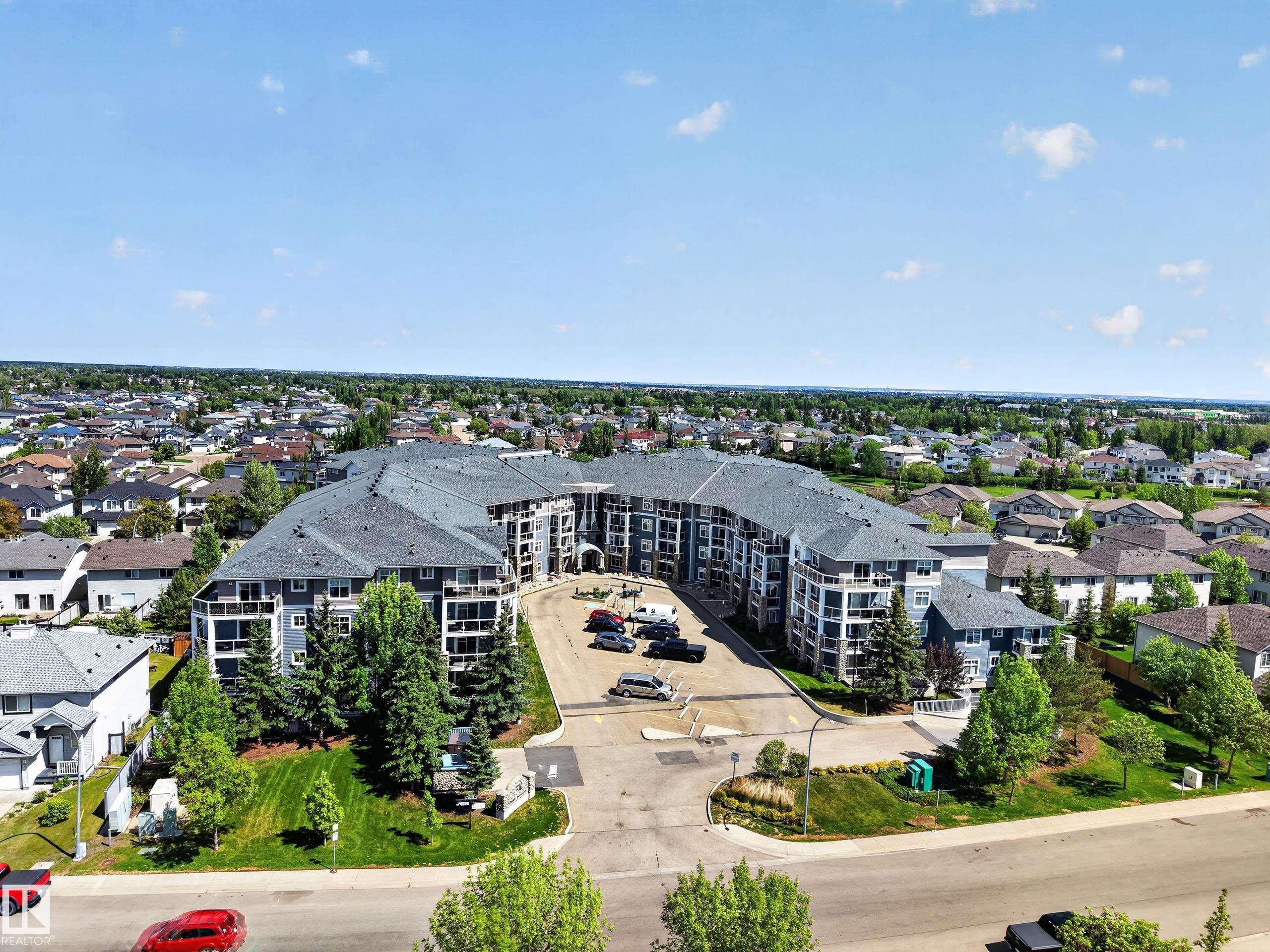 Multi-level residential building with a grey shingle roof and light blue siding - 138 16035 132 Street, Edmonton, AB