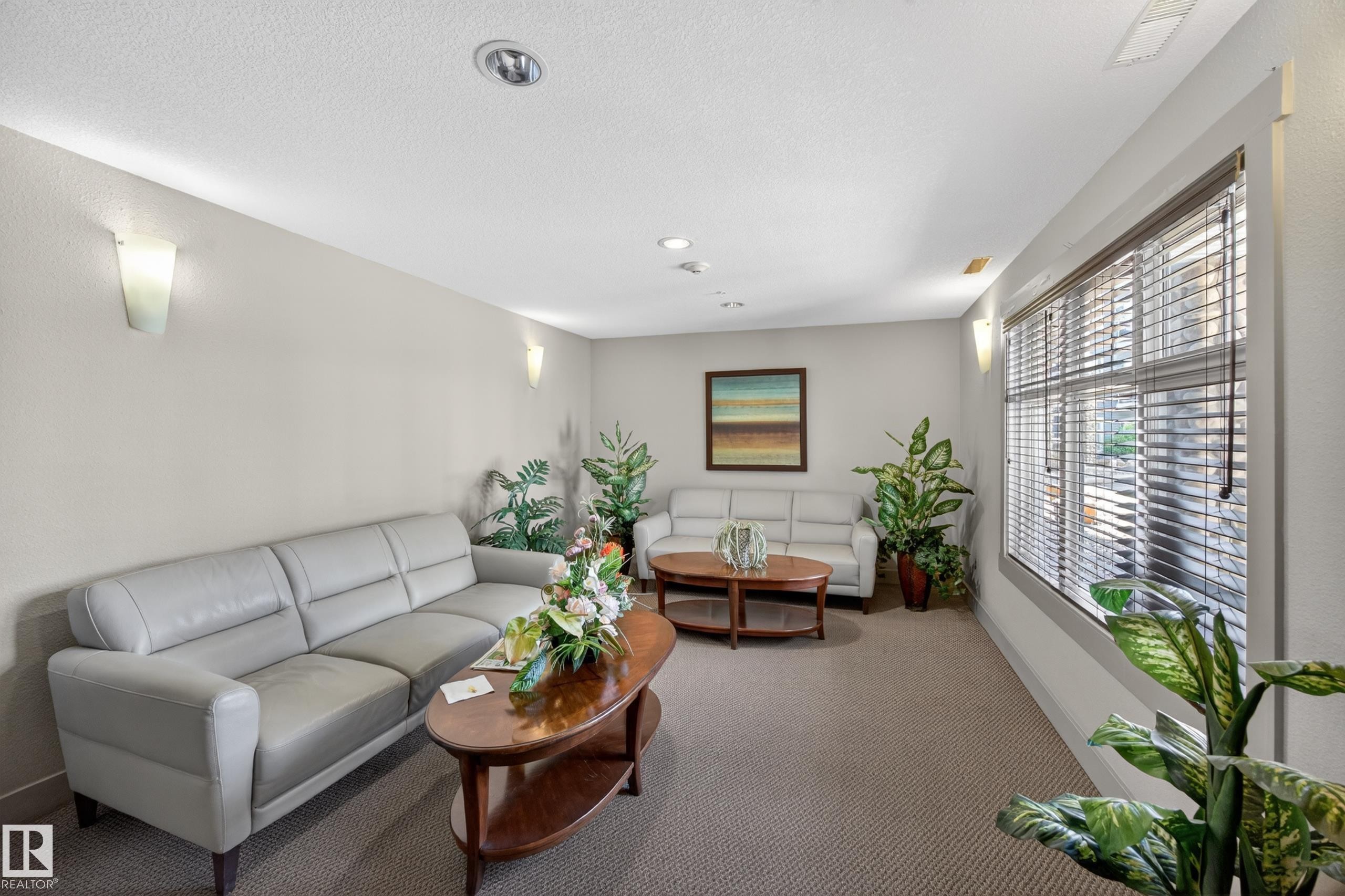 Spacious room featuring carpeting, recessed lighting, and wall sconces - 138 16035 132 Street, Edmonton, AB