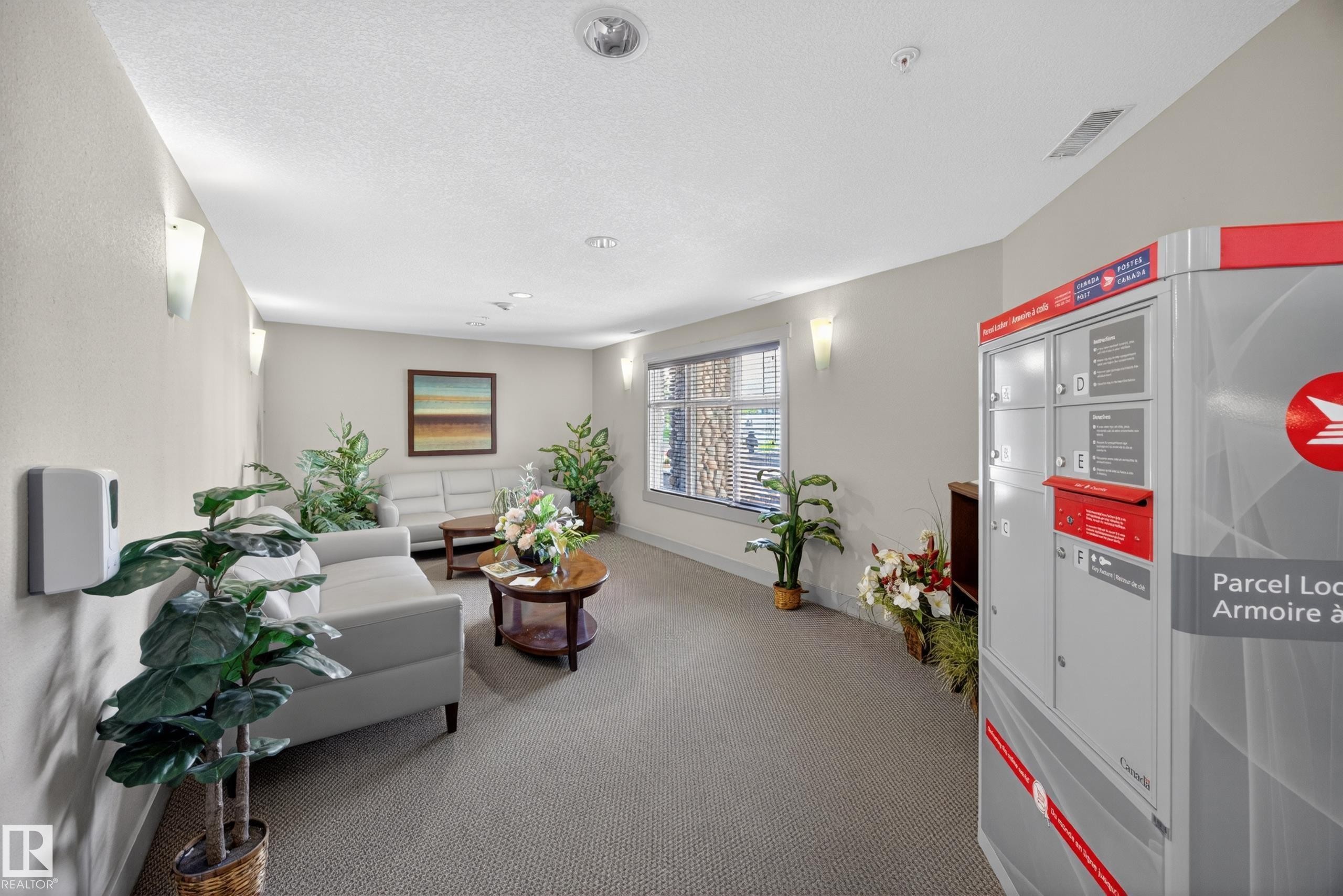 Carpeted common area featuring recessed lighting and wall sconces - 138 16035 132 Street, Edmonton, AB