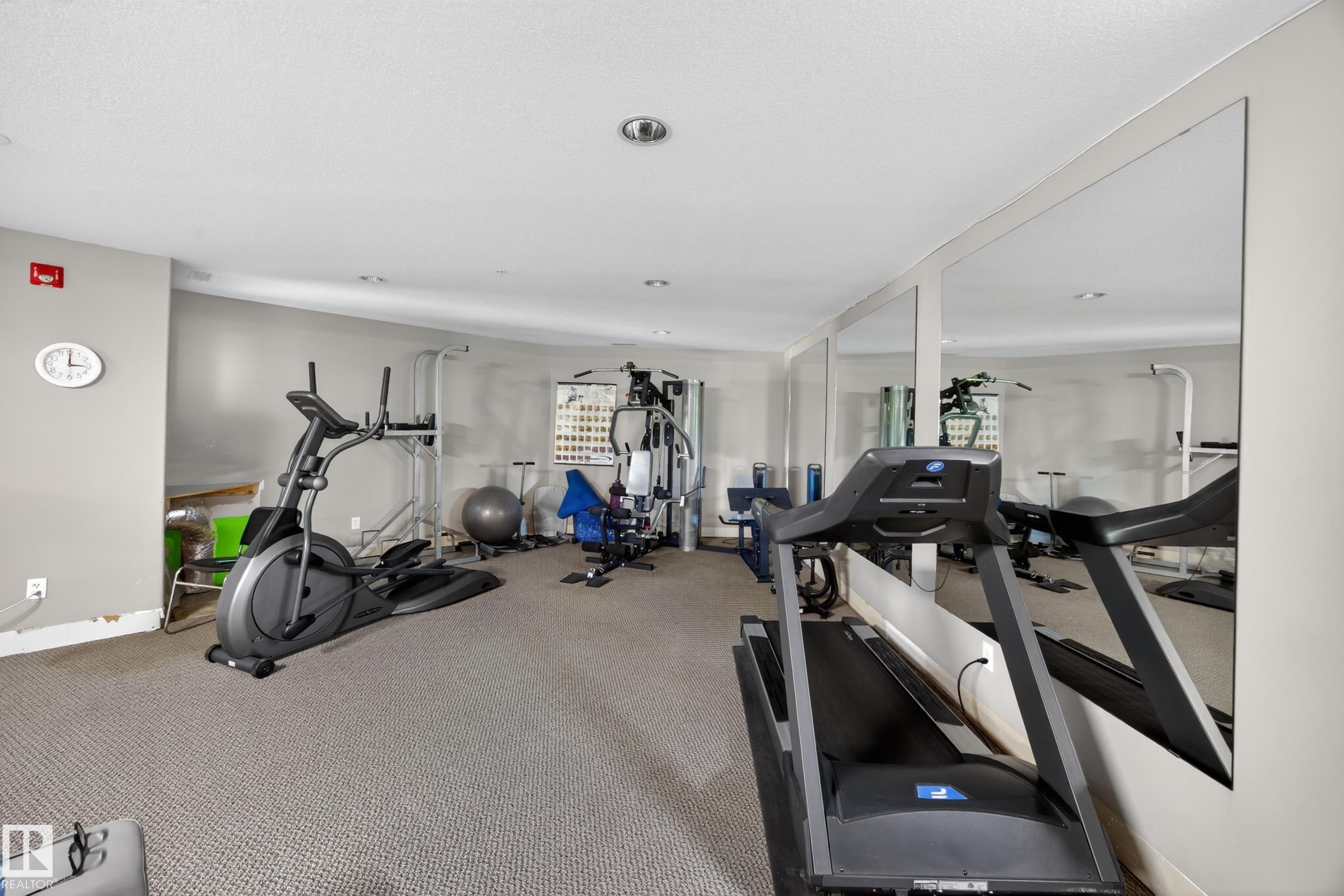Carpeted fitness area with recessed lighting and full-height wall mirrors - 138 16035 132 Street, Edmonton, AB