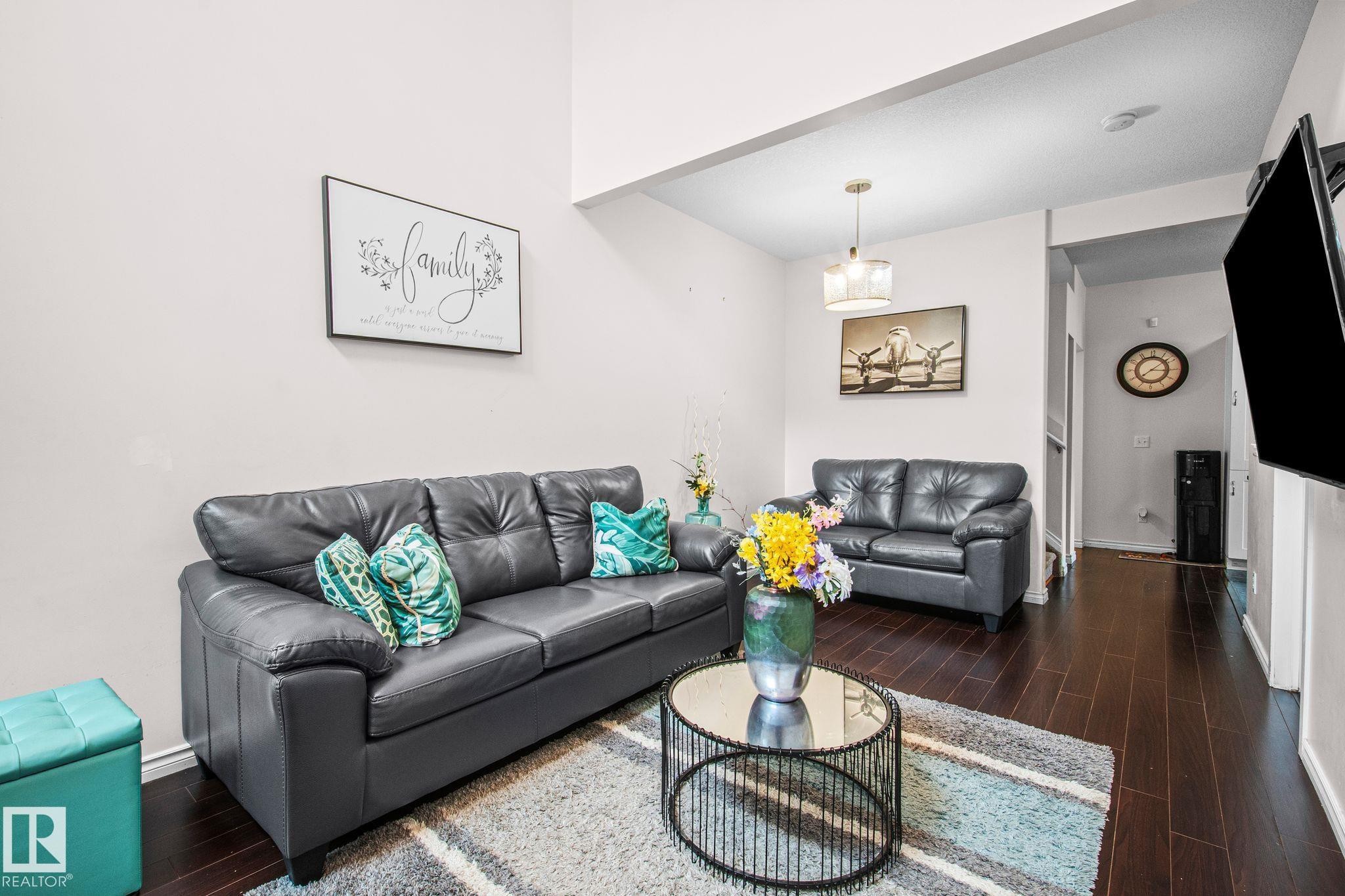 Living area featuring dark wood-finish flooring and light-toned walls - 4806 117 Ave, Edmonton, AB