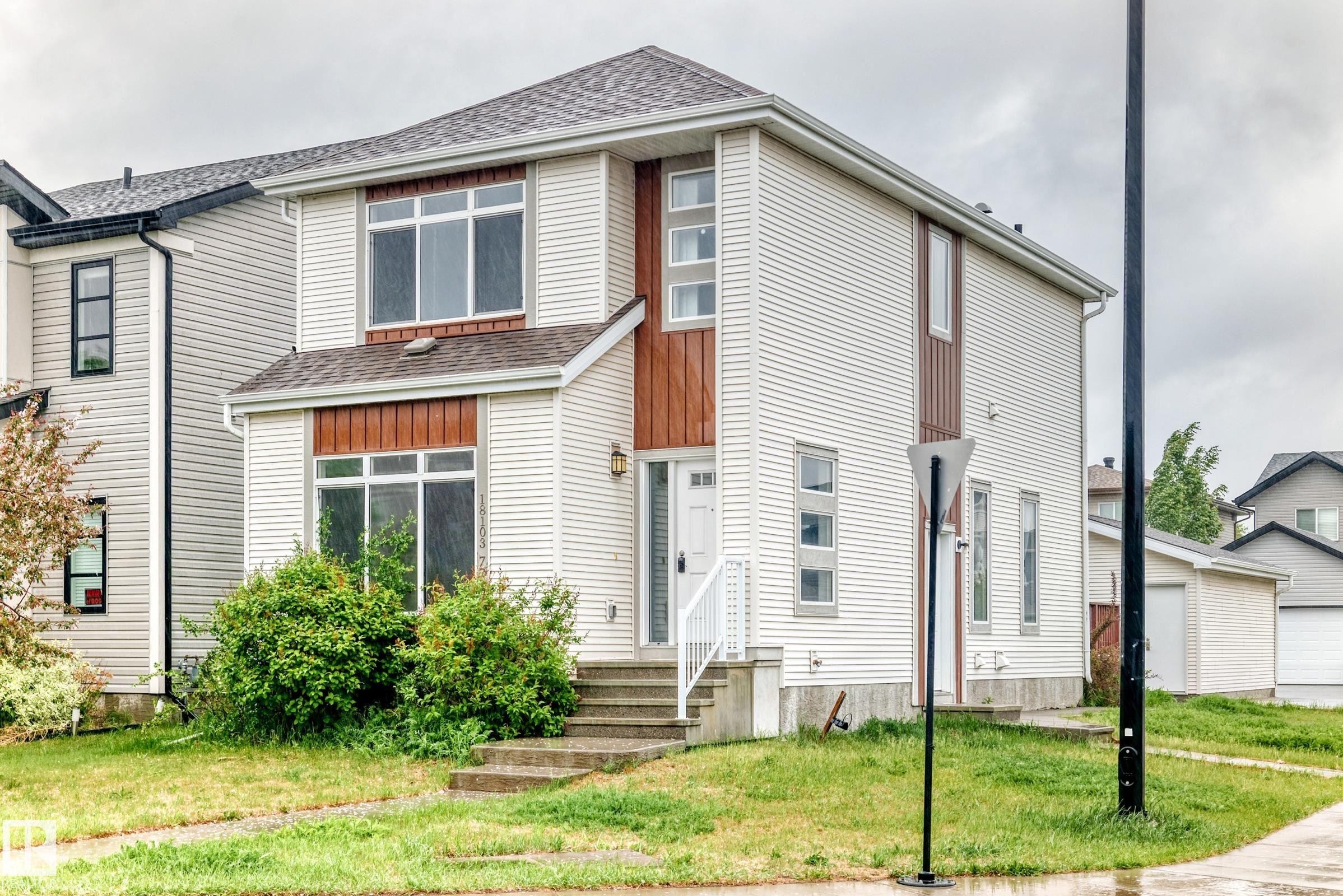 Two-story residence featuring white siding and brown accent panels - 18103 77 Street, Edmonton, AB