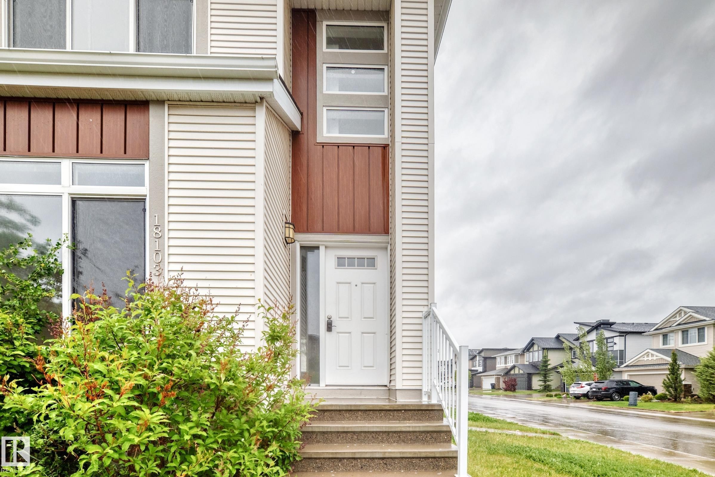 Multi-level facade featuring horizontal siding and vertical wood-look accents - 18103 77 Street, Edmonton, AB