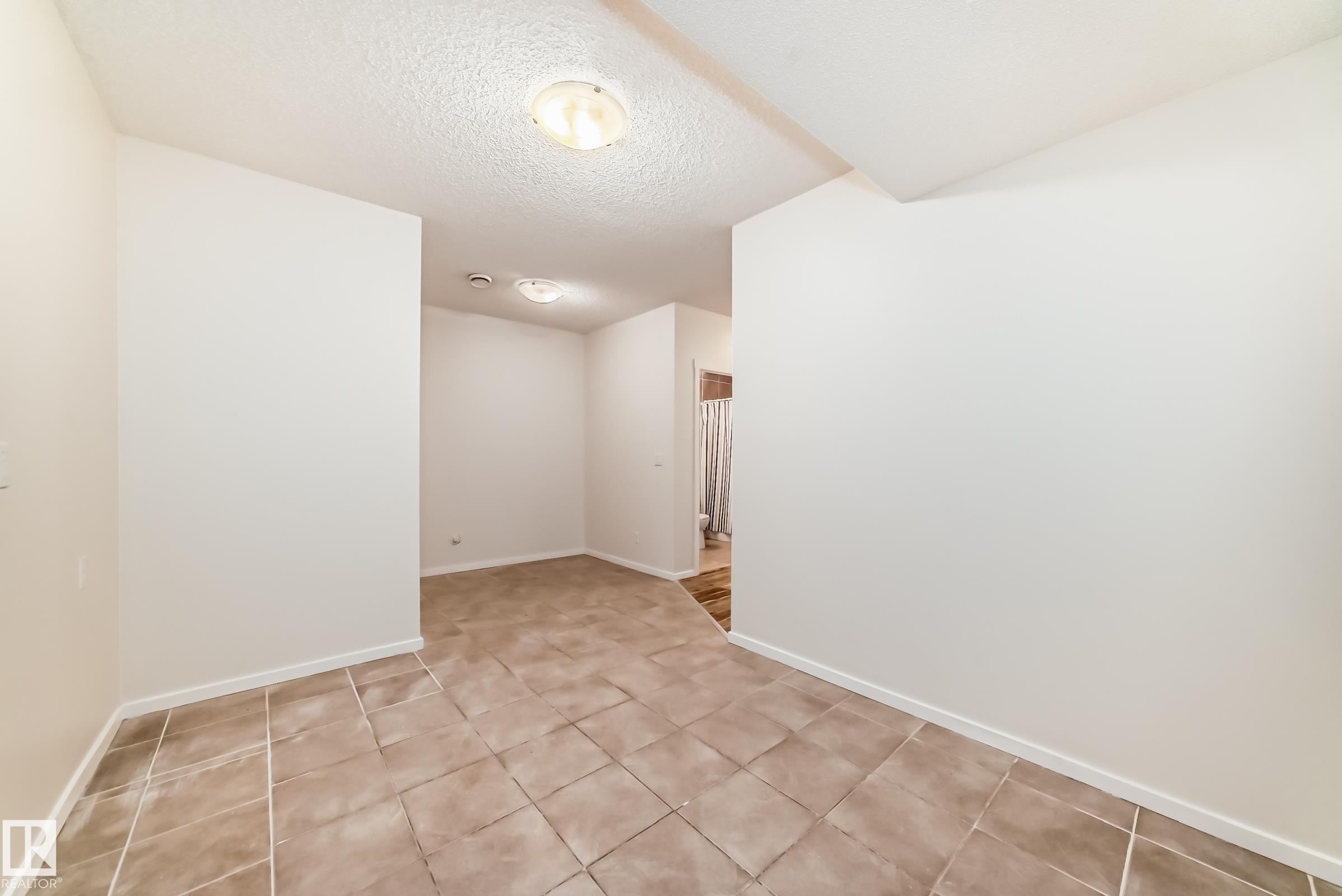 Entry area featuring square tile flooring and neutral wall tones - 18103 77 Street, Edmonton, AB