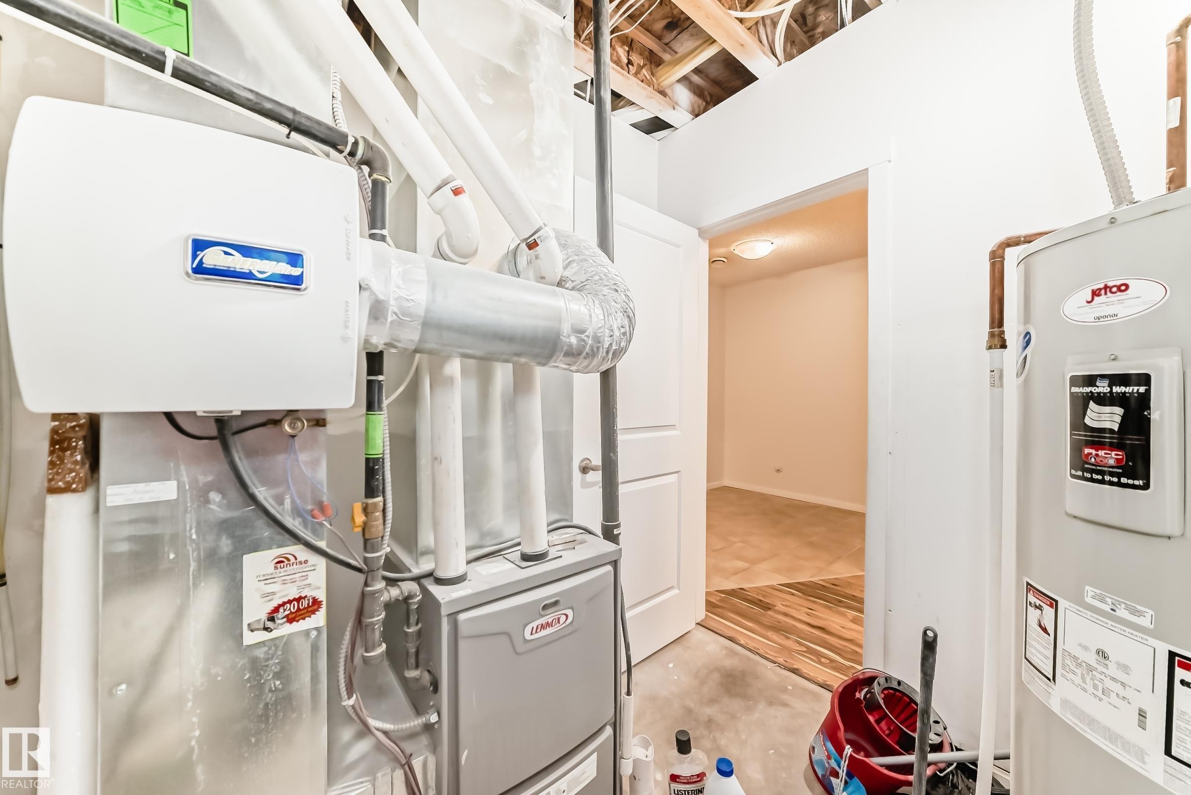Utility area featuring a water heater, furnace, and exposed ceiling joists - 18103 77 Street, Edmonton, AB