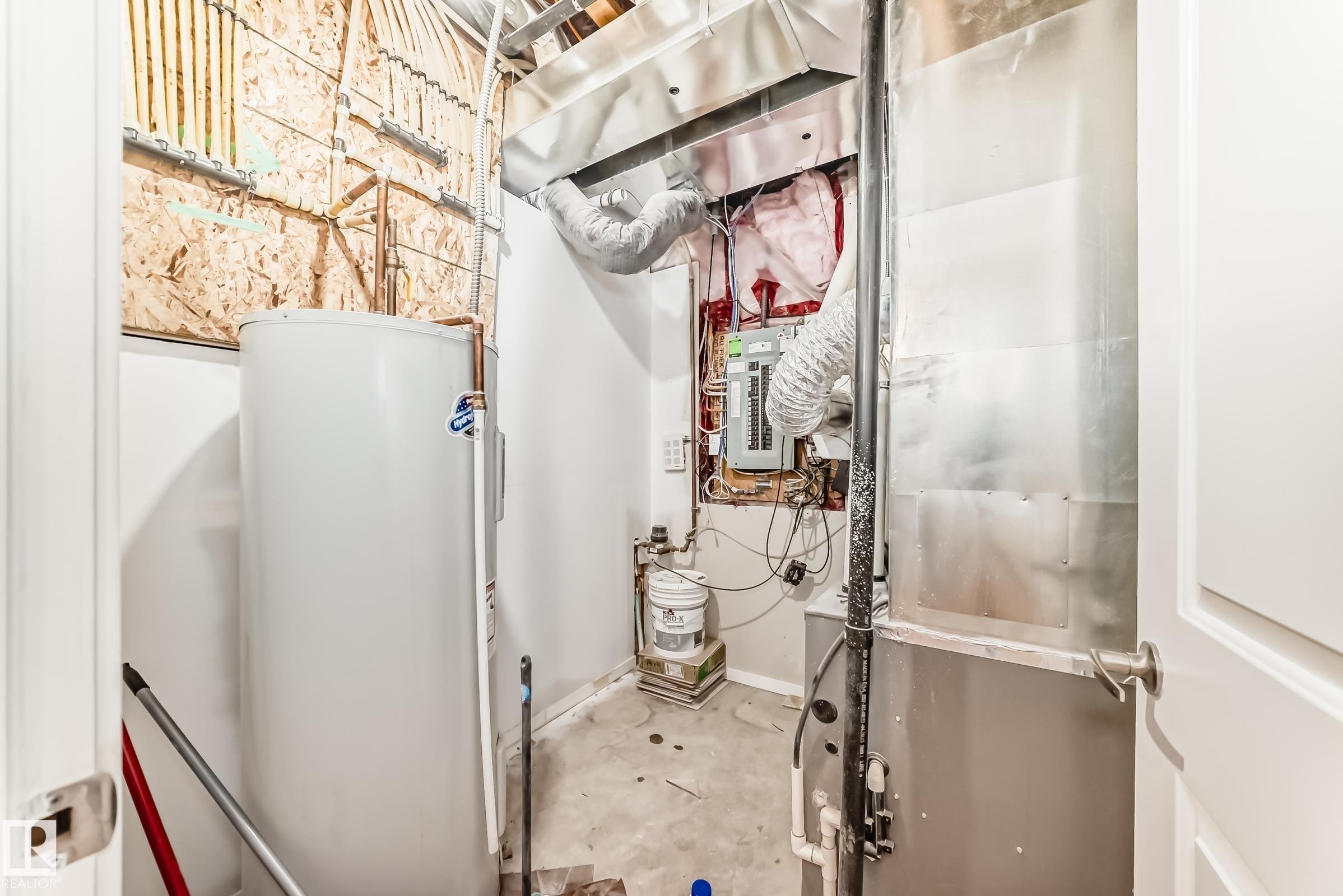 Utility area featuring a water heater, furnace, and exposed electrical panel - 18103 77 Street, Edmonton, AB