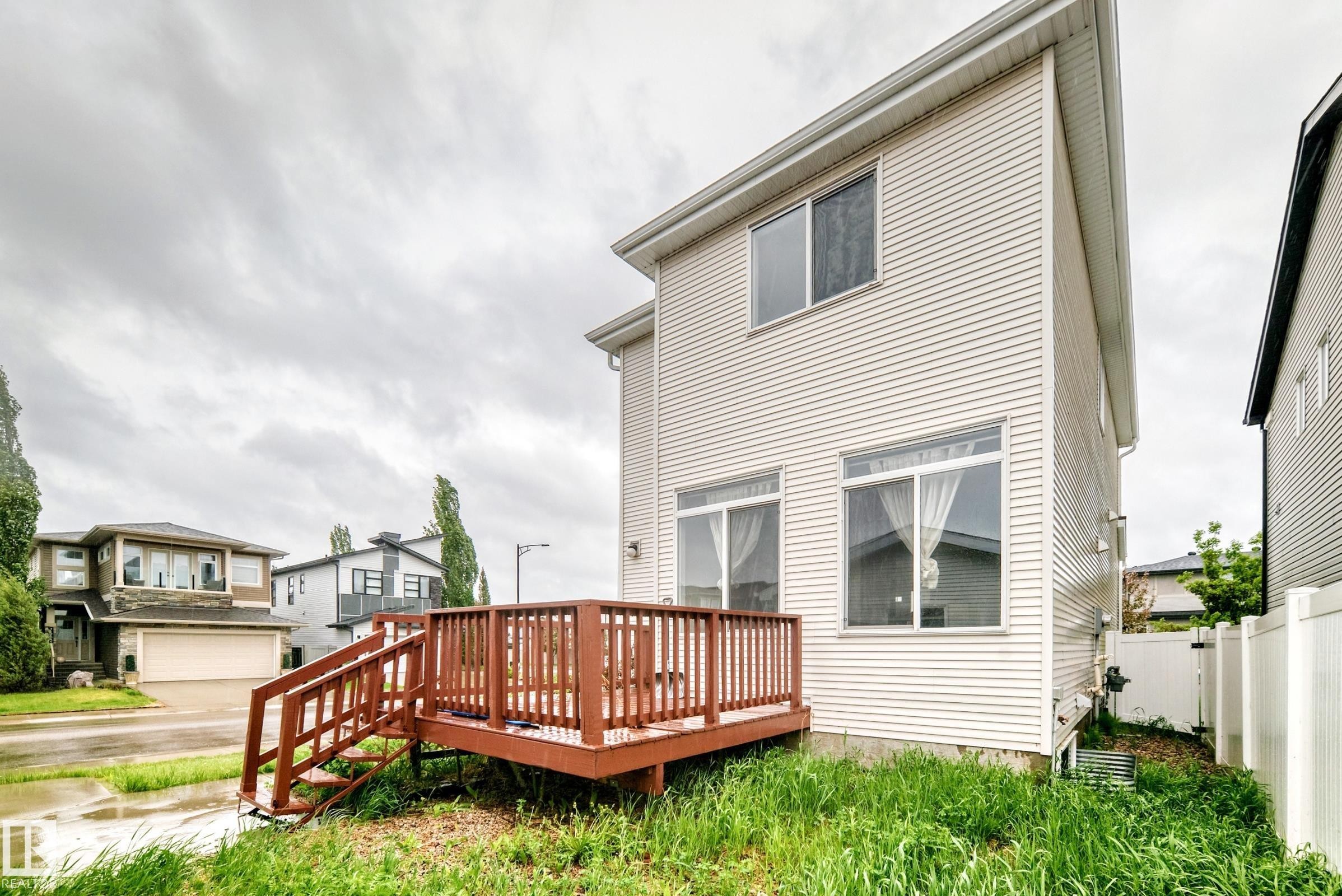 Exterior of a multi-story residence featuring light-colored horizontal siding - 18103 77 Street, Edmonton, AB