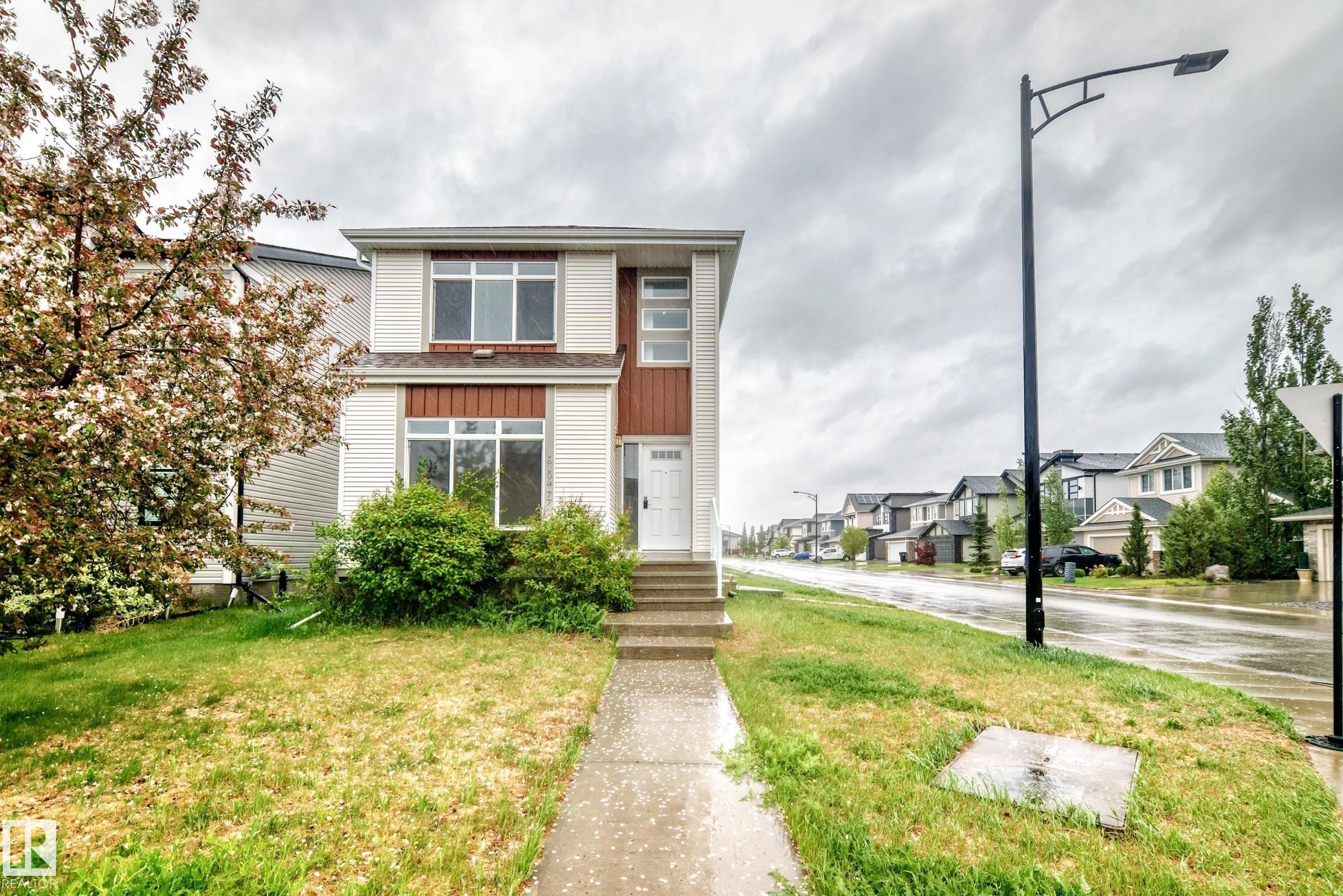 Two-story home with white siding and brown accent panels - 18103 77 Street, Edmonton, AB