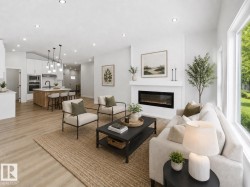 Open-concept living space featuring wood-finish flooring throughout, a modern electric fireplace with a white mantel, and large windows providing natural light -