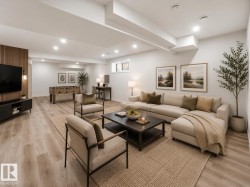 Spacious open-concept recreation room featuring recessed lighting, light wood-finish flooring, and a textured accent wall -