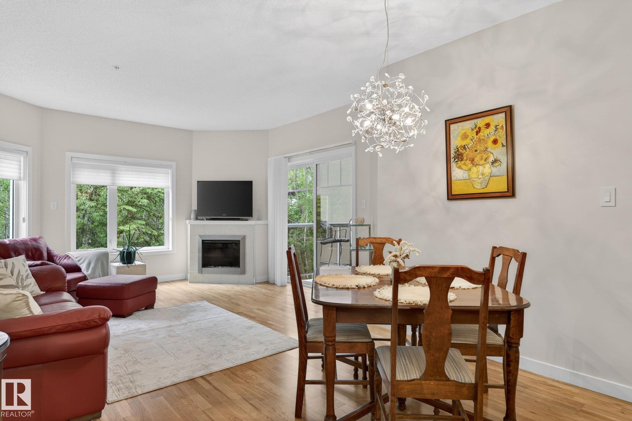 Open-concept living and dining area featuring wood-finish flooring and light wall finishes - 208 5 Gate Avenue, St. Albert, AB