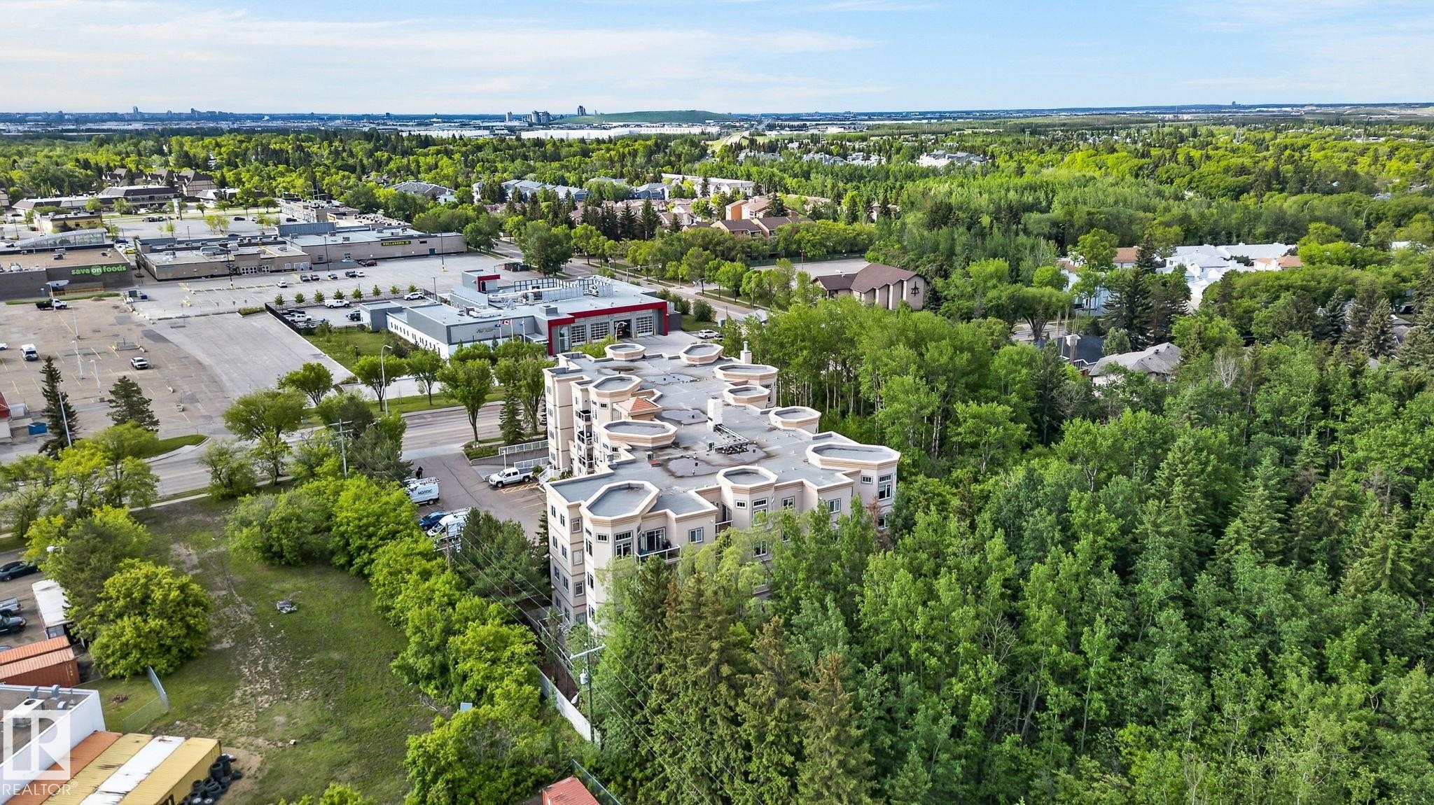 Contemporary multi-story building featuring a light-toned facade and prominent curved balconies - 208 5 Gate Avenue, St. Albert, AB