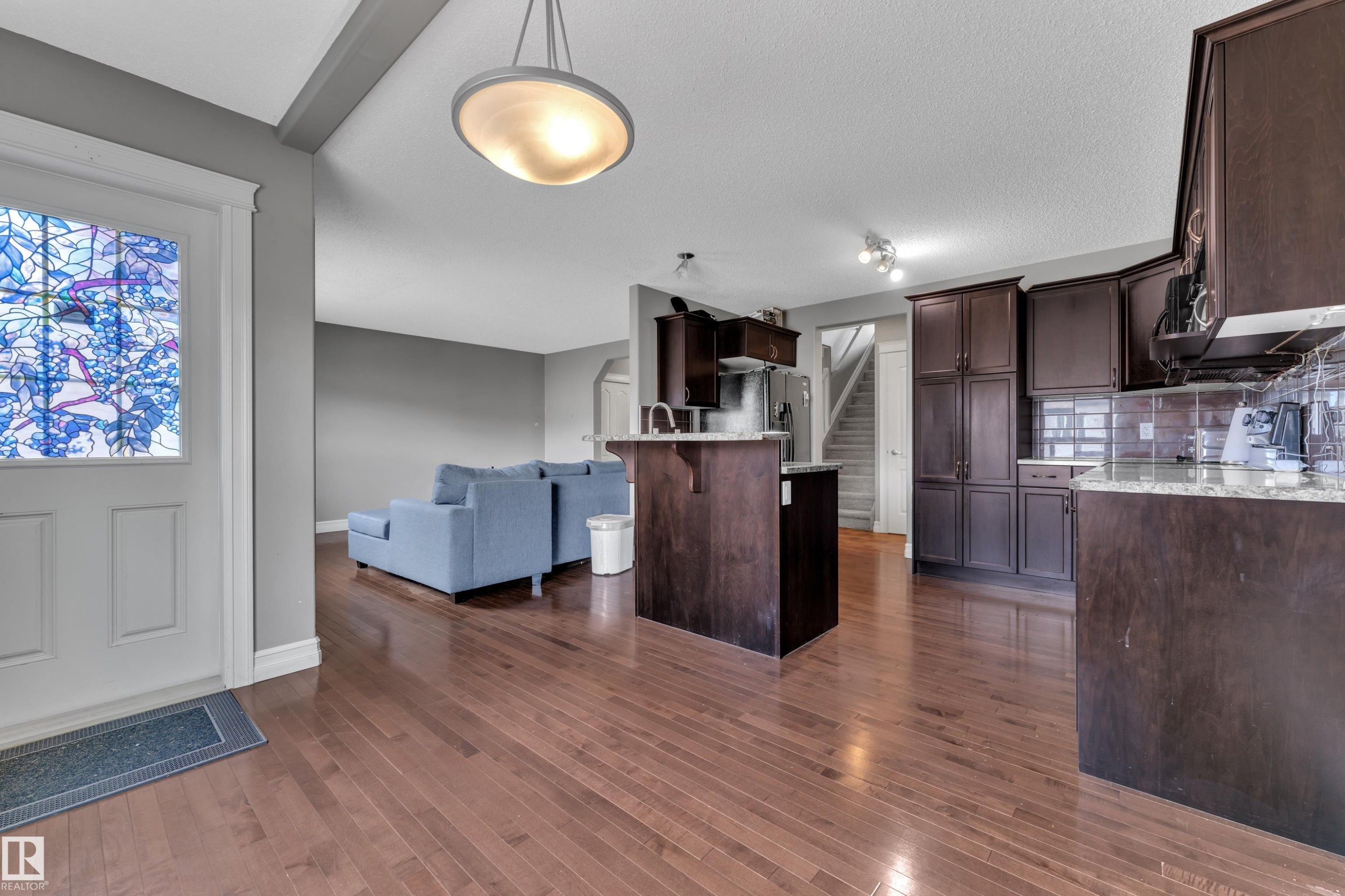 Expansive wood-finish flooring throughout the main level - 6116 11 Avenue, Edmonton, AB