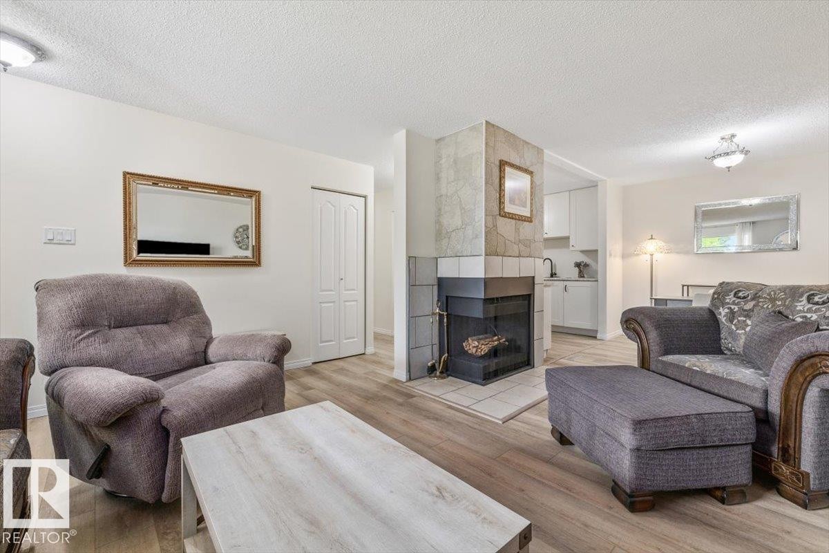 #42 3111 142 Av Nw, Edmonton, AB - Indoor Photo Showing Living Room With Fireplace