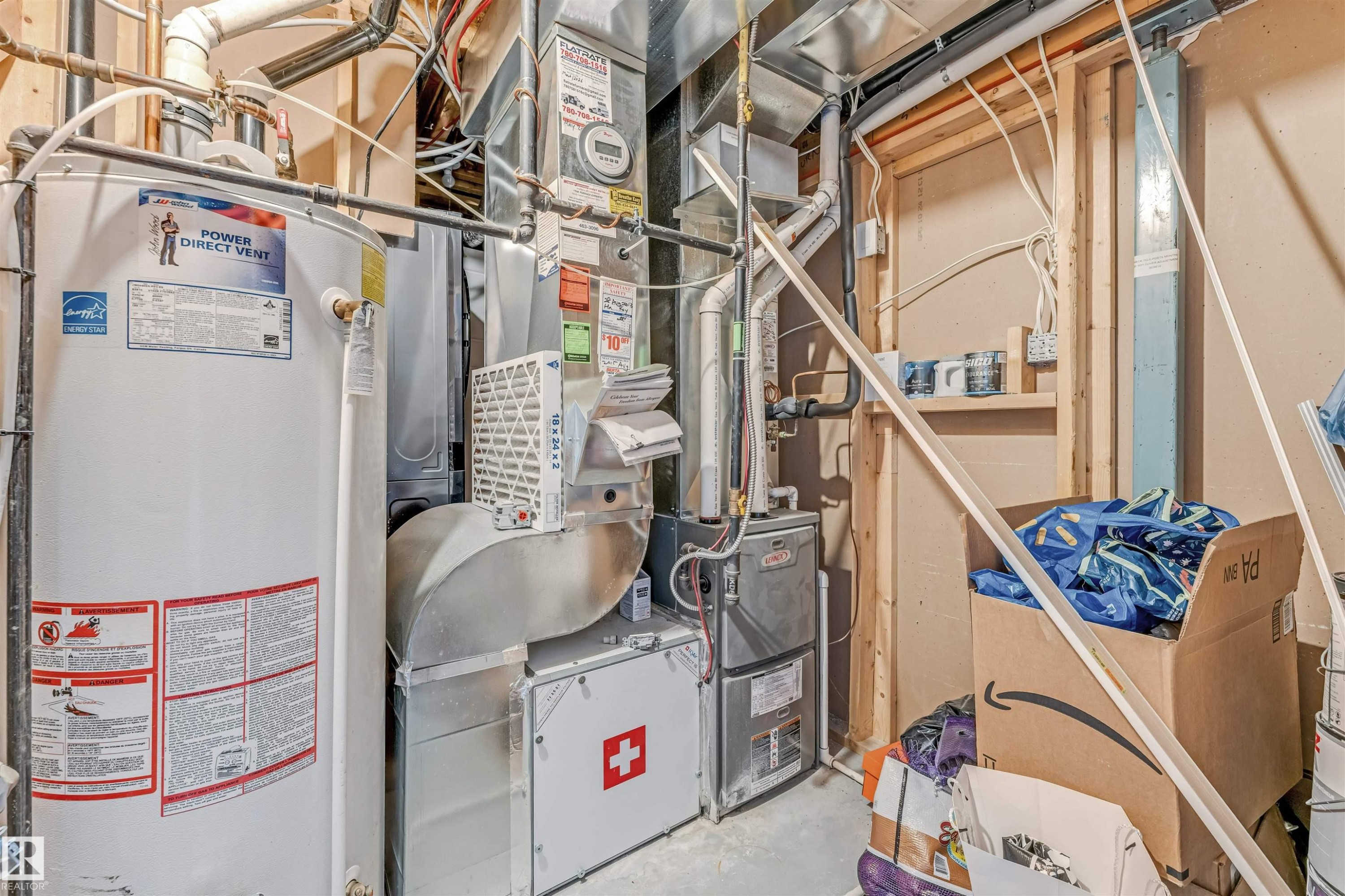 Water heater and furnace units featuring visible ductwork and piping - 5928 12 Avenue, Edmonton, AB