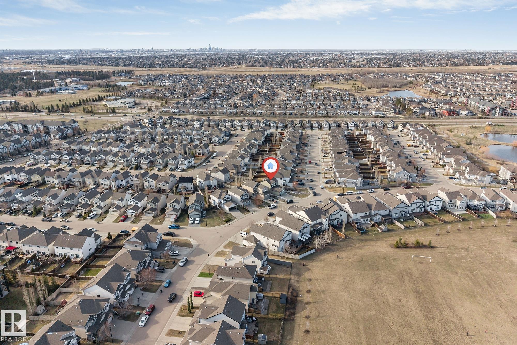 Residential neighborhood featuring a mix of detached and attached homes with dark roofs and light-colored siding - 5928 12 Avenue, Edmonton, AB