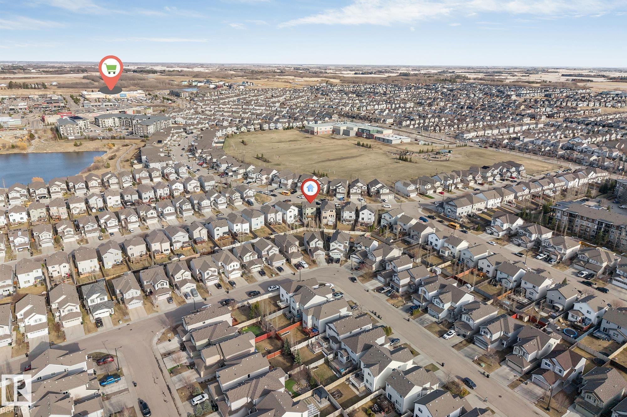 Residential neighborhood featuring a consistent architectural style, organized street layout, and a nearby body of water - 5928 12 Avenue, Edmonton, AB