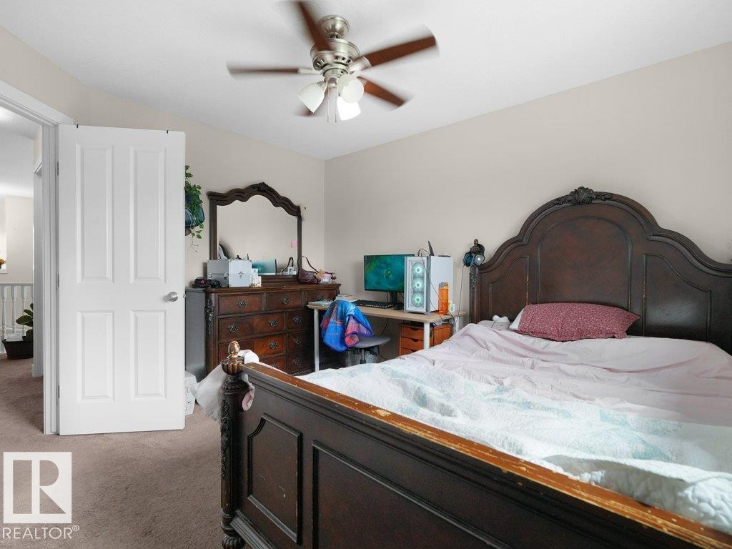 Bedroom featuring light-toned wall paint and an overhead ceiling fan with light fixture - 3756 8 Street, Edmonton, AB