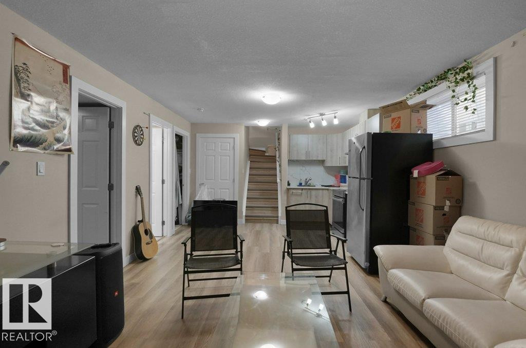 Open-concept living space featuring wood-finish flooring throughout - 3756 8 Street, Edmonton, AB