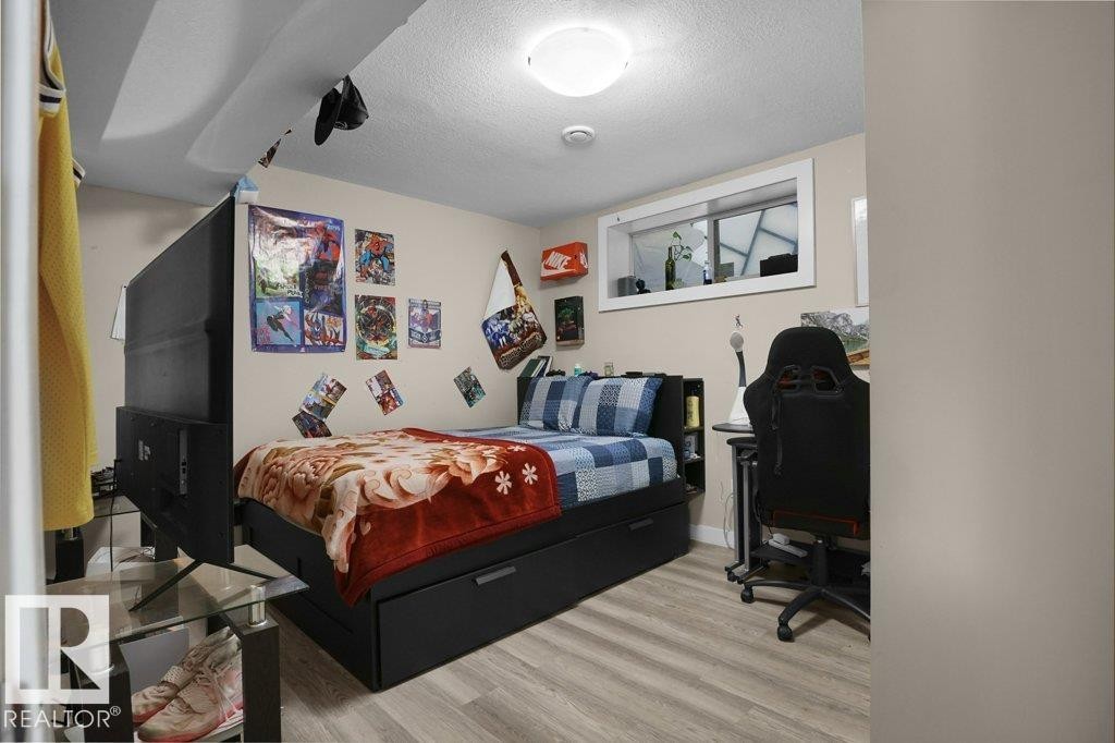 Room featuring light wood-finish flooring and neutral wall tones - 3756 8 Street, Edmonton, AB