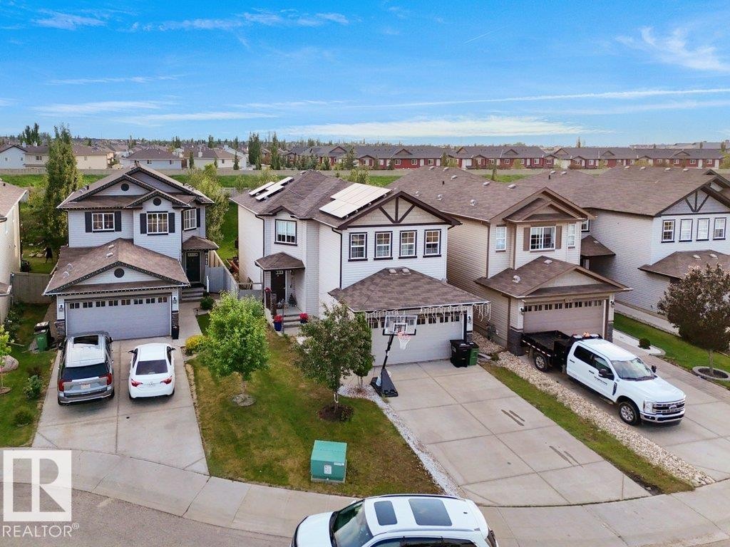 Contemporary two-story residence featuring a two-car garage, concrete driveway, and front lawn - 3756 8 Street, Edmonton, AB