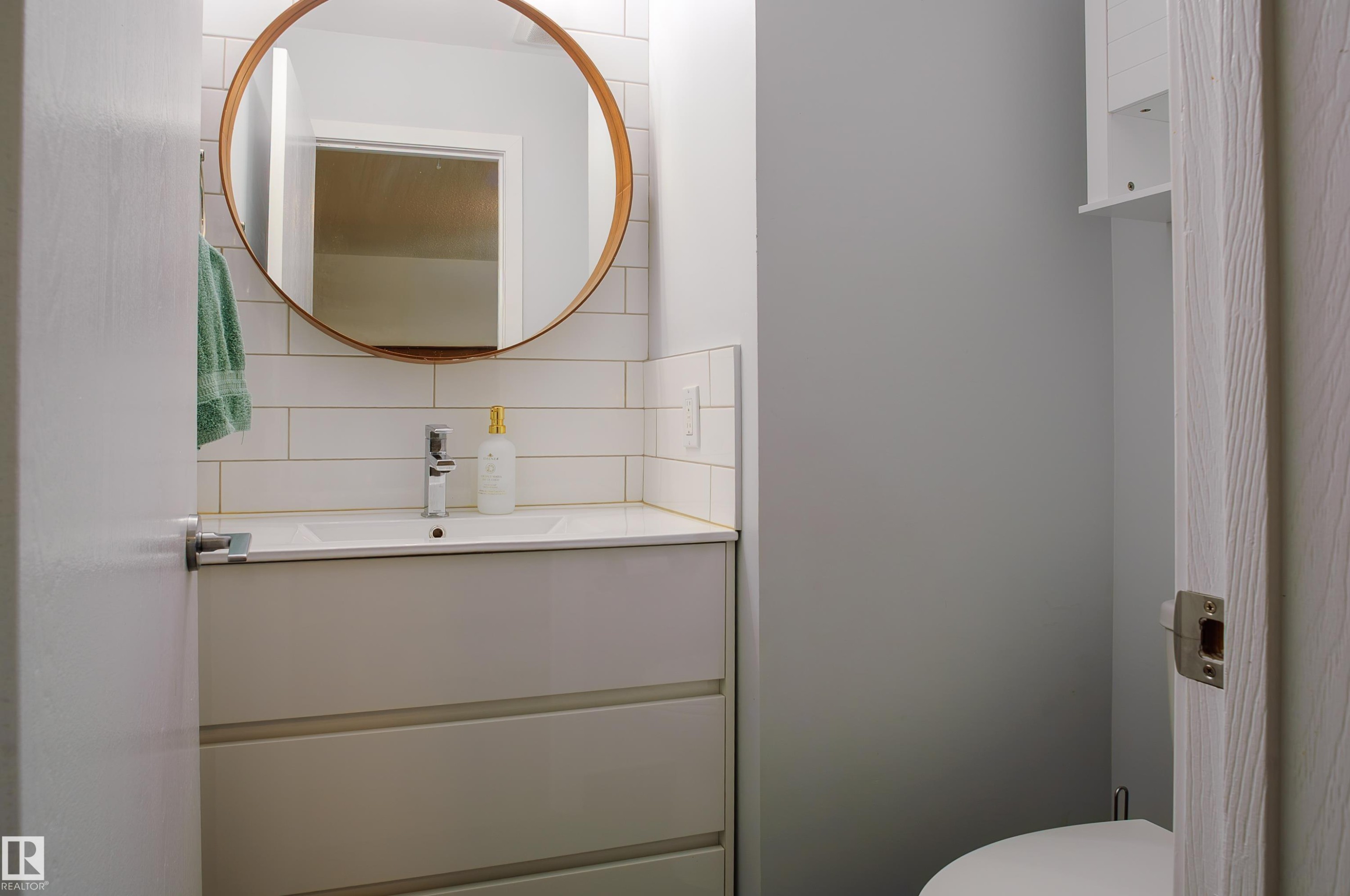 Modern bathroom vanity with integrated sink and chrome faucet - 58 Lodgepole Crescent, St. Albert, AB