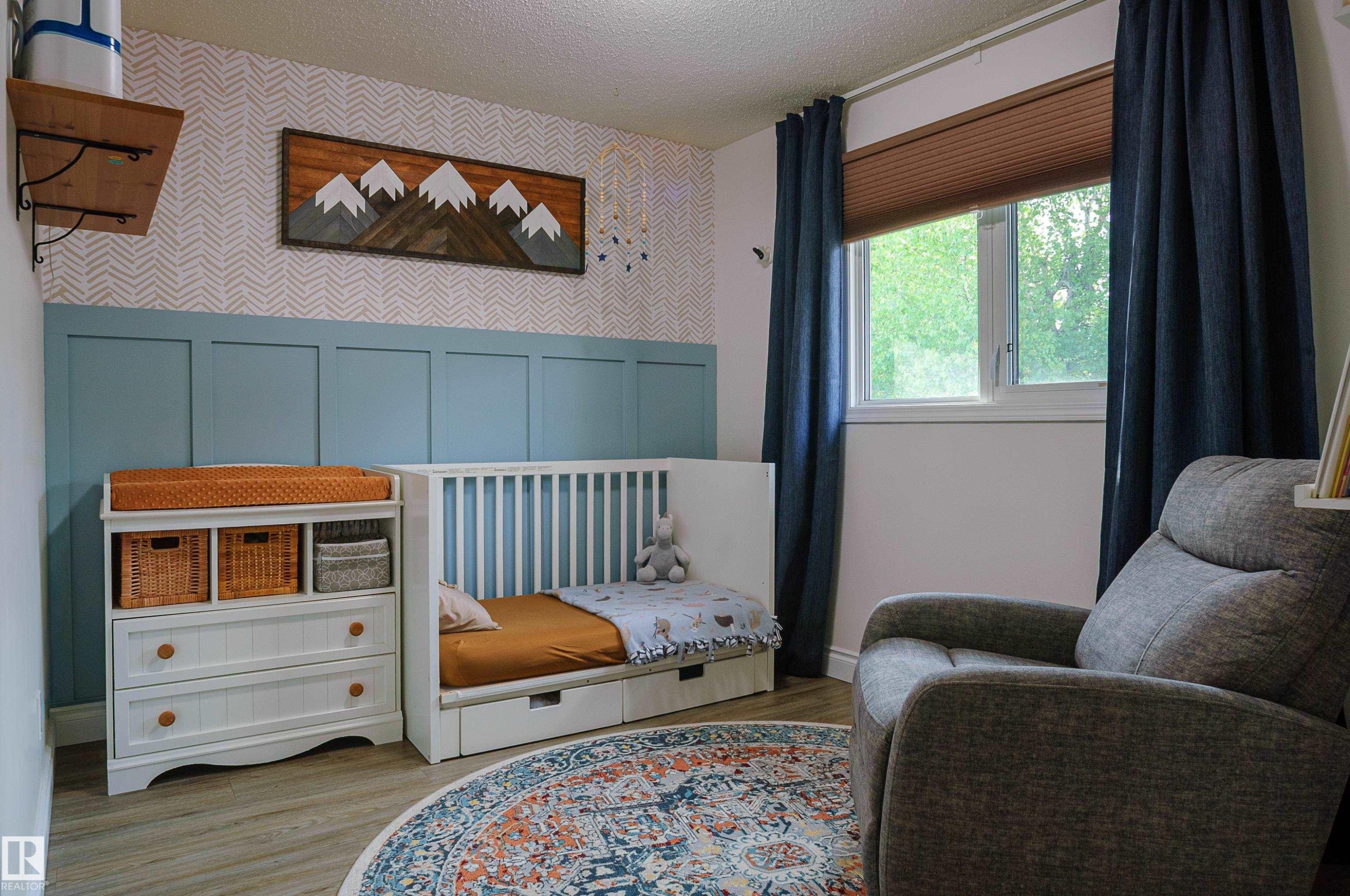 Wall-mounted shelving with decorative brackets, a single window with blinds and drapes, and wood-finish flooring - 58 Lodgepole Crescent, St. Albert, AB